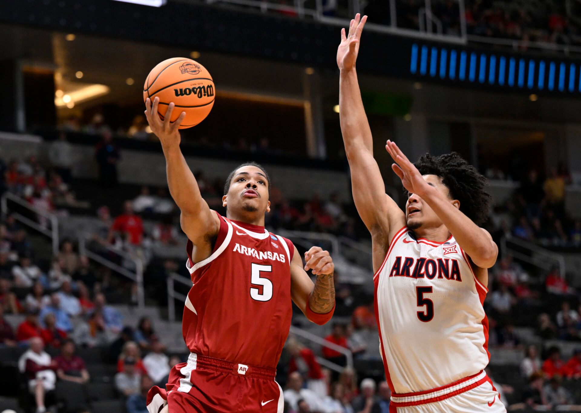 Arkansas Razorbacks guard Darius Acuff Jr. (5) shoots past Arizona Wildcats guard Brayden Burries (5) in the second half during a Sweet Sixteen game of the West Regional of the men's 2026 NCAA Tournament at SAP Center.