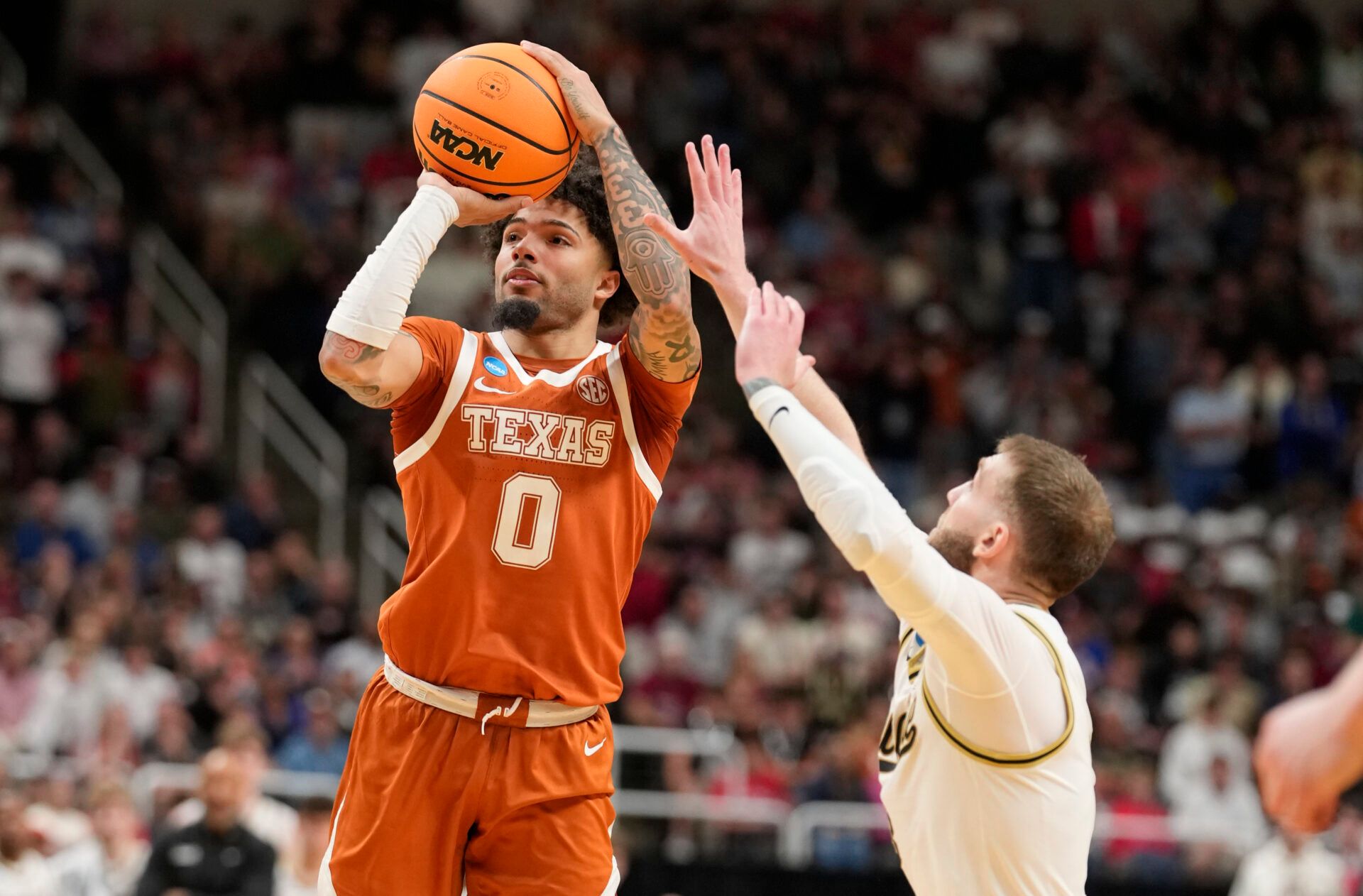 Texas Longhorns guard Jordan Pope (0) shoots past Purdue Boilermakers guard Braden Smith (3) in the second half during a Sweet Sixteen game of the West Regional of the men's 2026 NCAA Tournament at SAP Center.