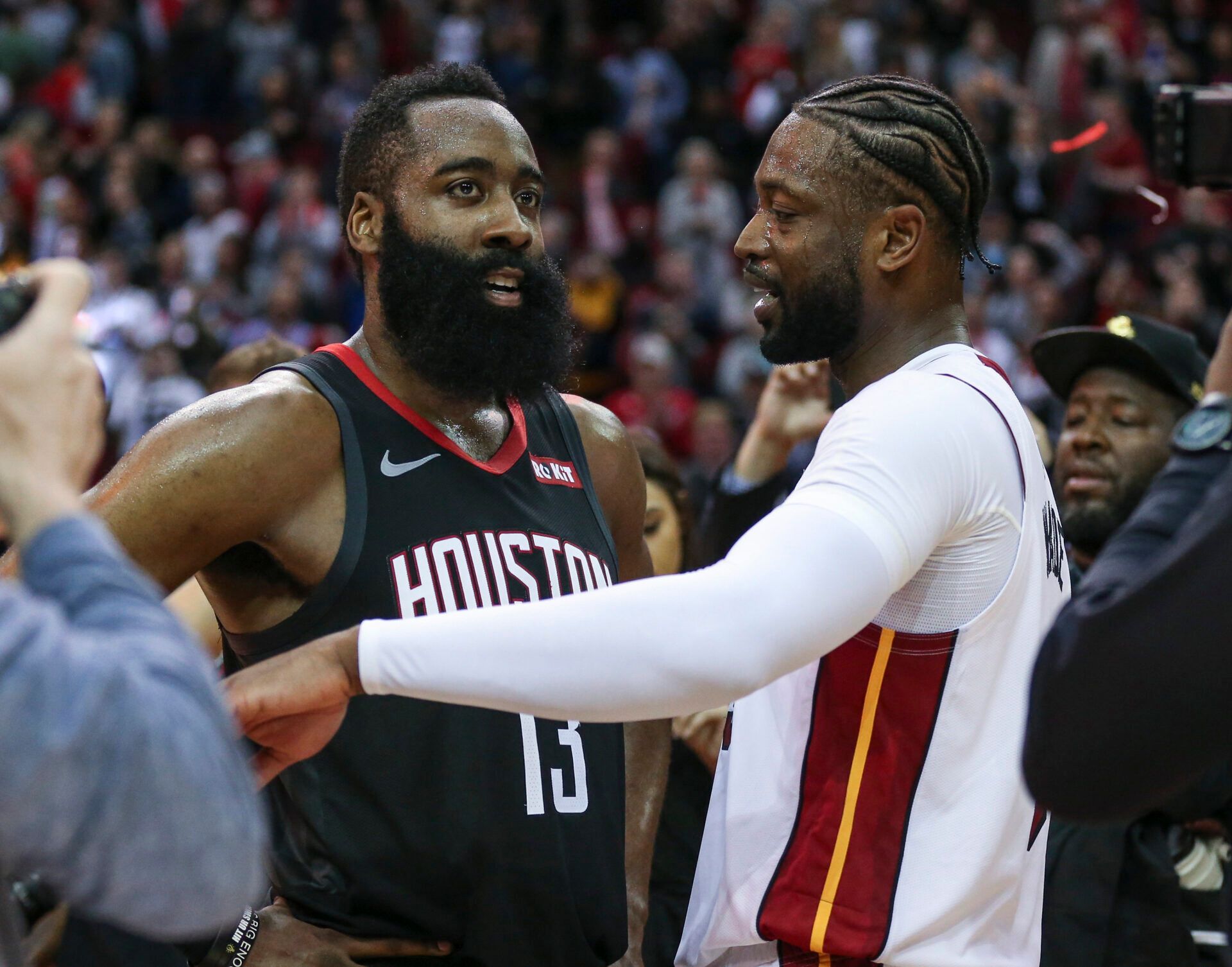 Houston Rockets guard James Harden (13) and Miami Heat guard Dwyane Wade (3) talk on the court after the game at Toyota Center.