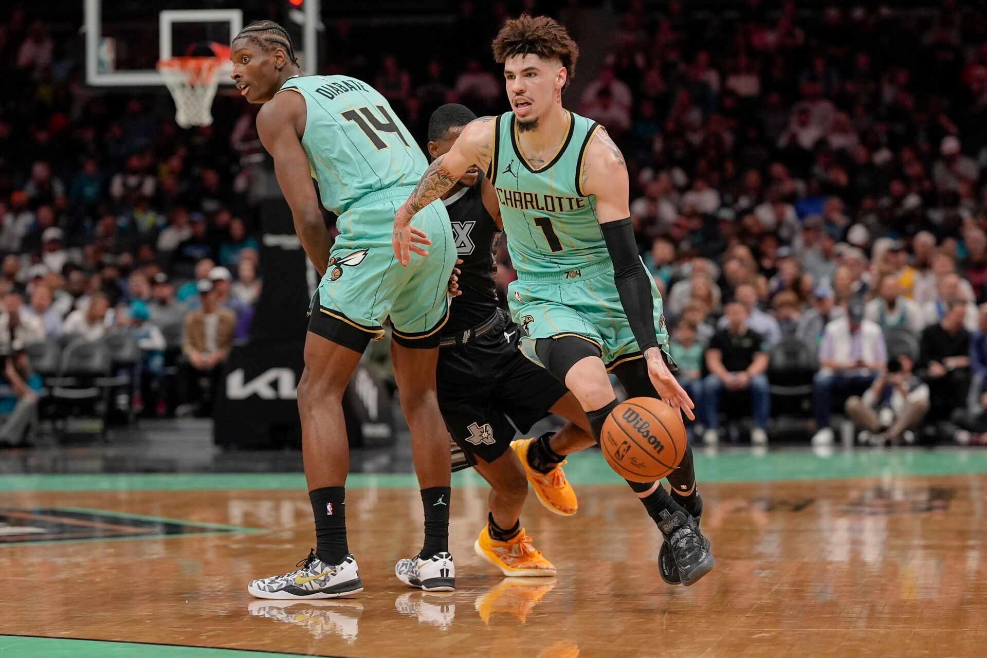 Charlotte Hornets guard LaMelo Ball (1) dribbles around a pick by forward Moussa Diabate (14) against the San Antonio Spurs during the first quarter at Spectrum Center.