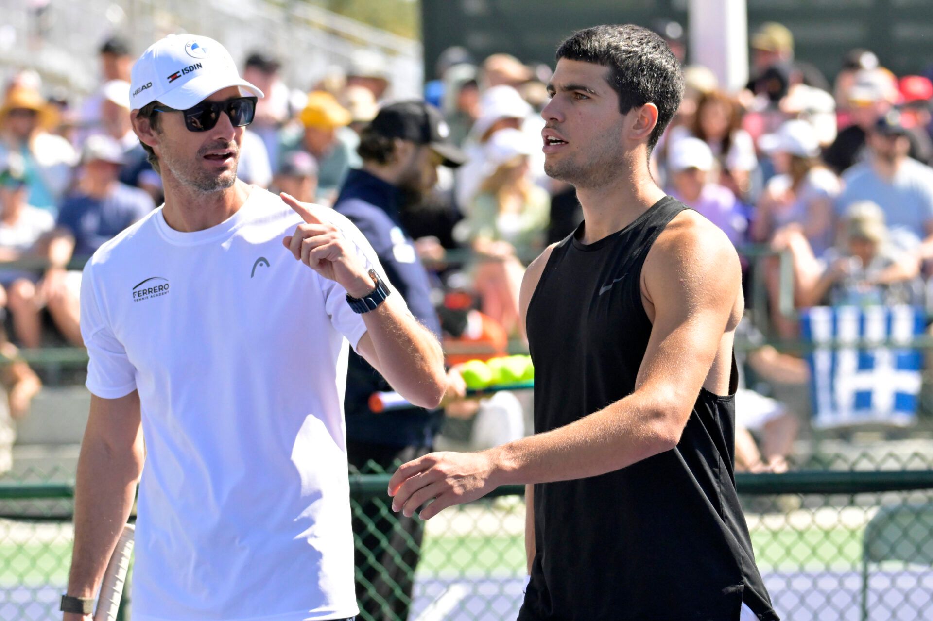 Tennis coach Juan Carlos Ferrero talks with Carlos Alcaraz (ESP) on the practice courts during the BNP Paribas Open at the Indian Wells Tennis Garden.