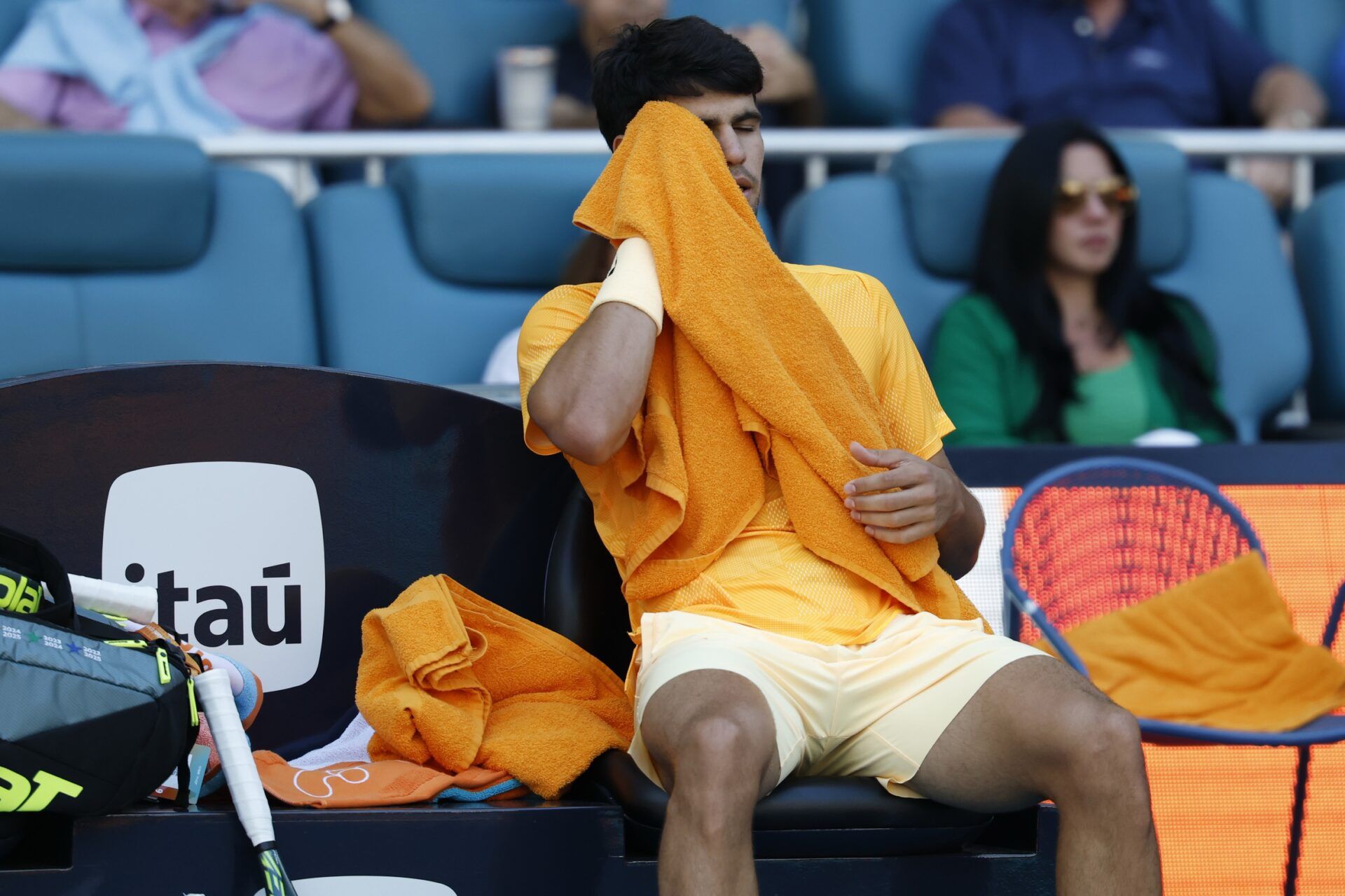 Carlos Alcaraz (ESP) wipes his face in his player's chair during a changeover against Sebastian Korda (USA) (not pictured) on day six of the 2026 Miami Open at Hard Rock Stadium.