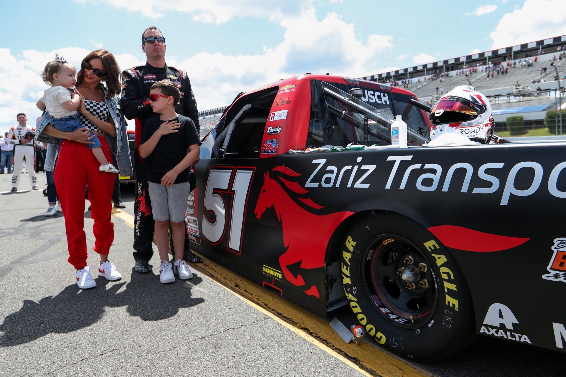 NASCAR Craftsman Truck Series driver Kyle Busch stands with his wife Samantha Busch and children Brexton and Lennix prior to the CRC Brakleen 150 at Pocono Raceway.