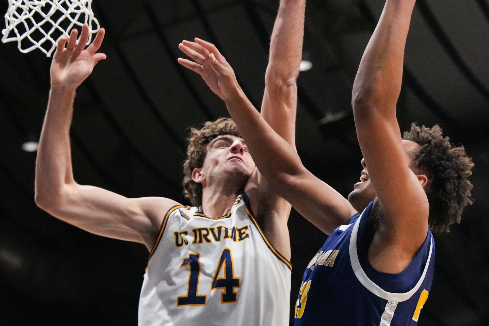 Chattanooga Mocs forward Latif Diouf (23) goes in for a lay-up against UC Irvine Anteaters forward Kyle Evans (14) on Thursday, April 3, 2025, during the National Invitional Tournament at Hinkle Fieldhouse in Indianapolis.