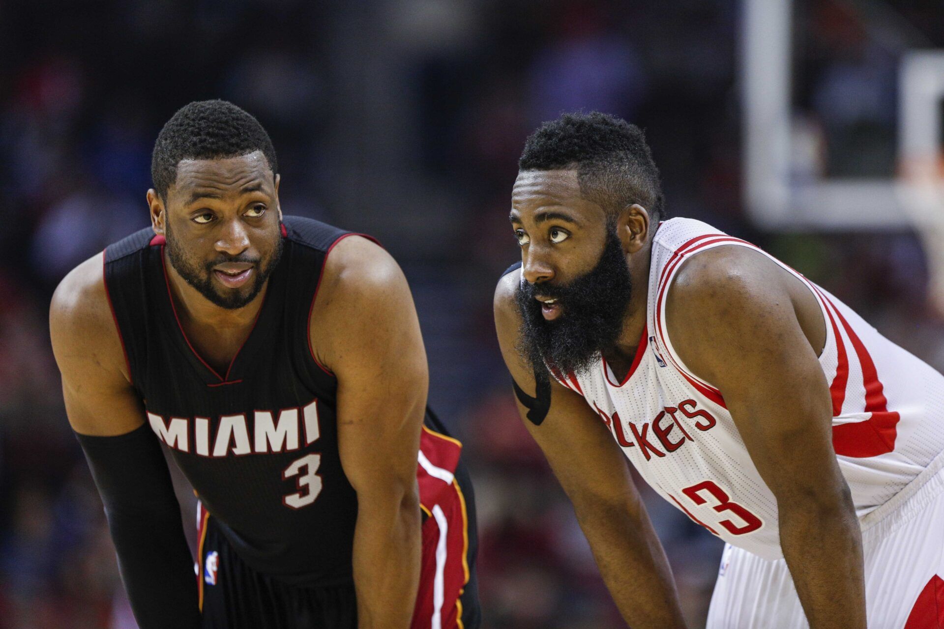 Miami Heat guard Dwyane Wade (3) and Houston Rockets guard James Harden (13) talk during the second quarter at Toyota Center.