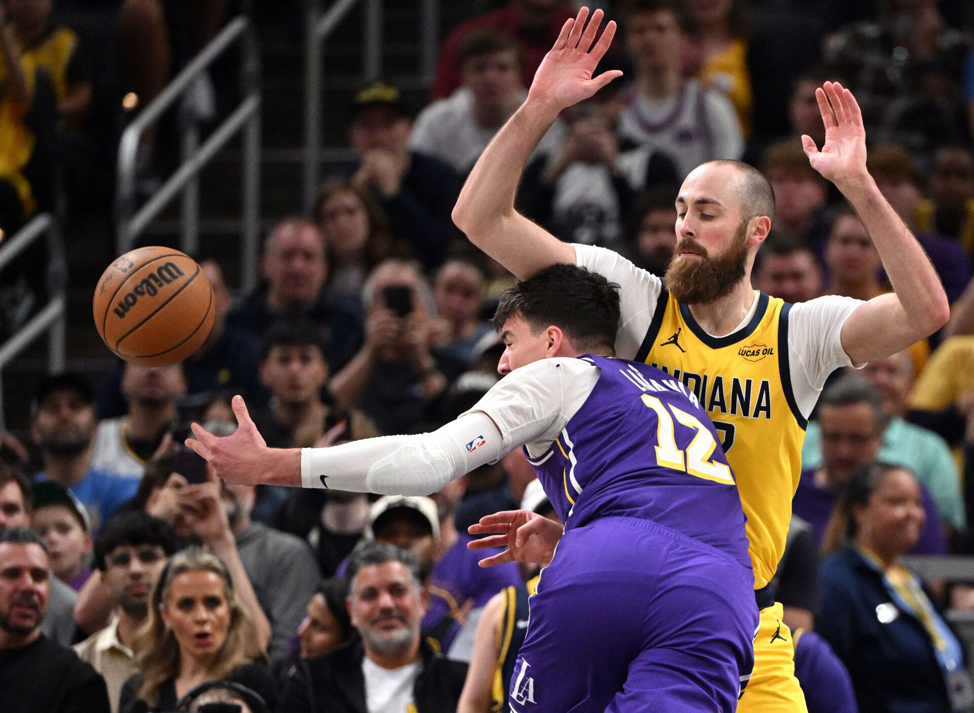 Los Angeles Lakers forward Jake LaRavia (12) runs into Indiana Pacers center Jay Huff (32) during the first quarter at Gainbridge Fieldhouse.