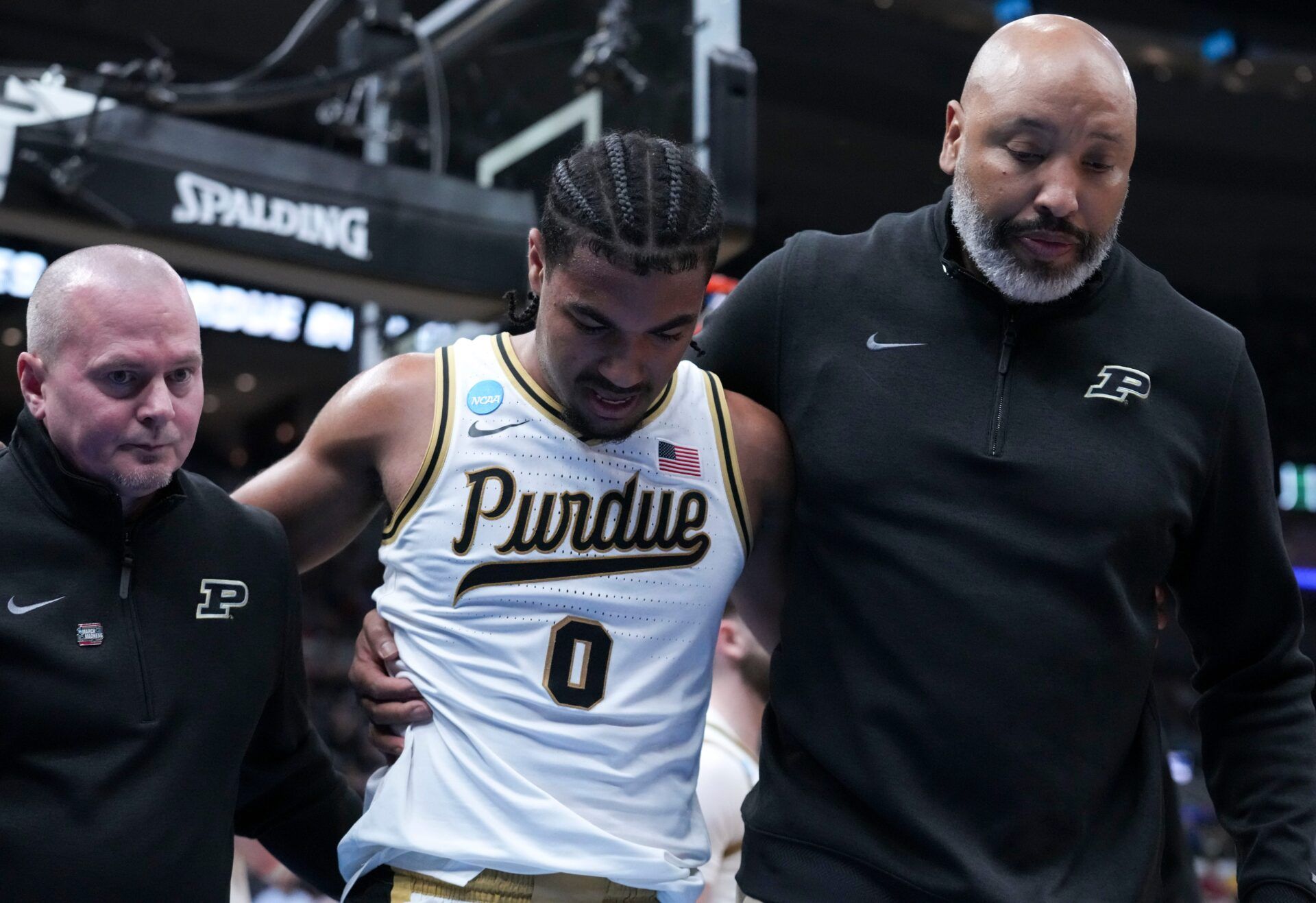 Purdue Boilermakers guard C.J. Cox (0) is walked off the court during a NCAA Tournament second round game against the Miami Hurricanes on Sunday, March 22, 2026, at Enterprise Center in St. Louis. Purdue defeated Miami 79-69.
