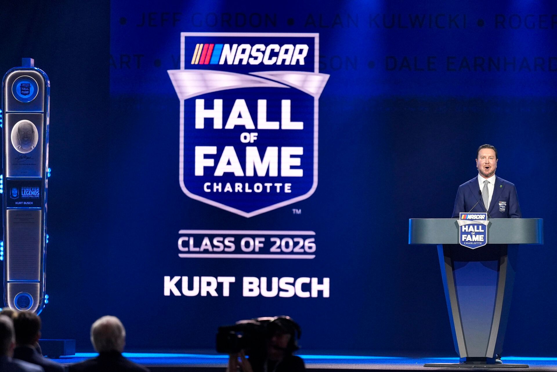 Kurt Busch speaks to the audience during the NASCAR Hall of Fame Induction at Charlotte Convention Center - Crown Ballroom.
