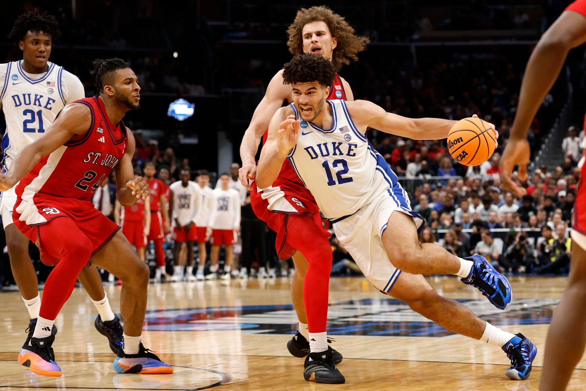 Duke Blue Devils forward Cameron Boozer (12) dribbles the ball past St. John's Red Storm forward Ruben Prey (17) in the second half during a Sweet Sixteen game of the East Regional of the men's 2026 NCAA Tournament at Capital One Arena.