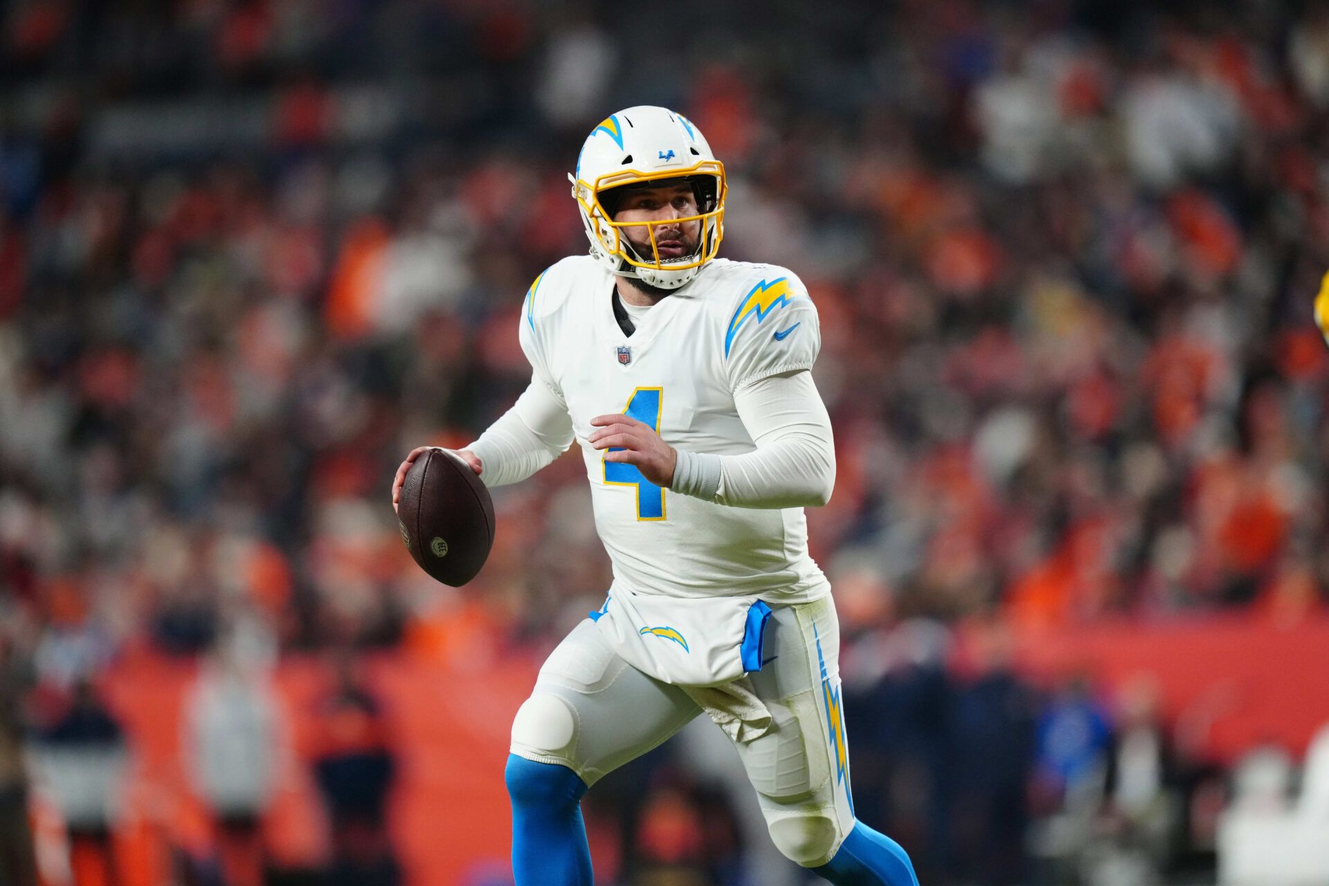 Los Angeles Chargers quarterback Chase Daniel (4) scrambles in the fourth quarter against the Denver Broncos at Empower Field at Mile High.