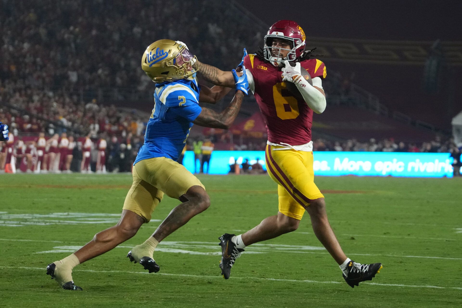 Southern California Trojans wide receiver Makai Lemon (6) carries the ball against UCLA Bruins defensive back Andre Jordan Jr. (2) in the second half at United Airlines Field at Los Angeles Memorial Coliseum.