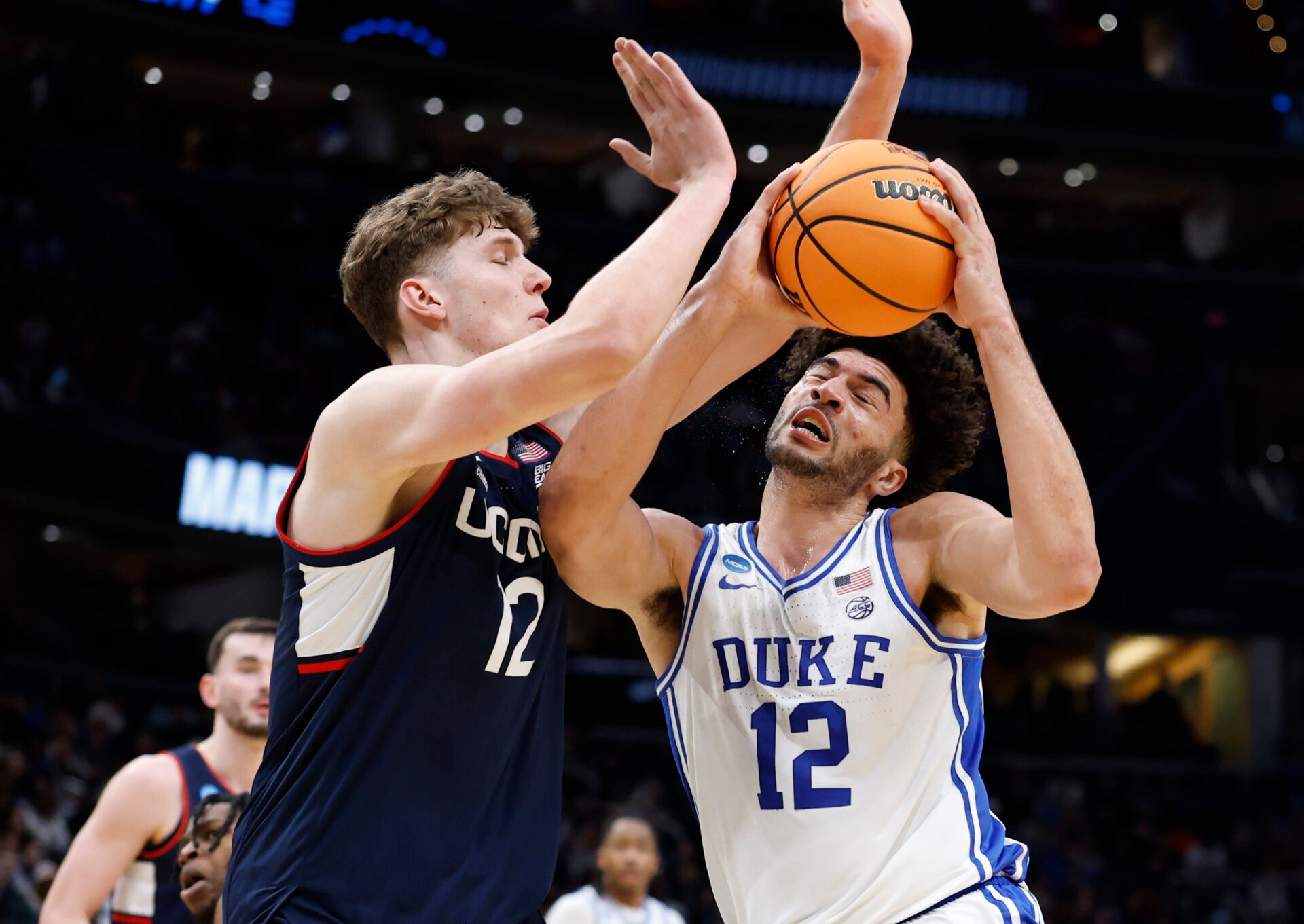 Duke Blue Devils forward Cameron Boozer (12) goes to the basket against UConn Huskies center Eric Reibe (12) in the first half during an Elite Eight game of the East Regional of the men's 2026 NCAA Tournament at Capital One Arena.