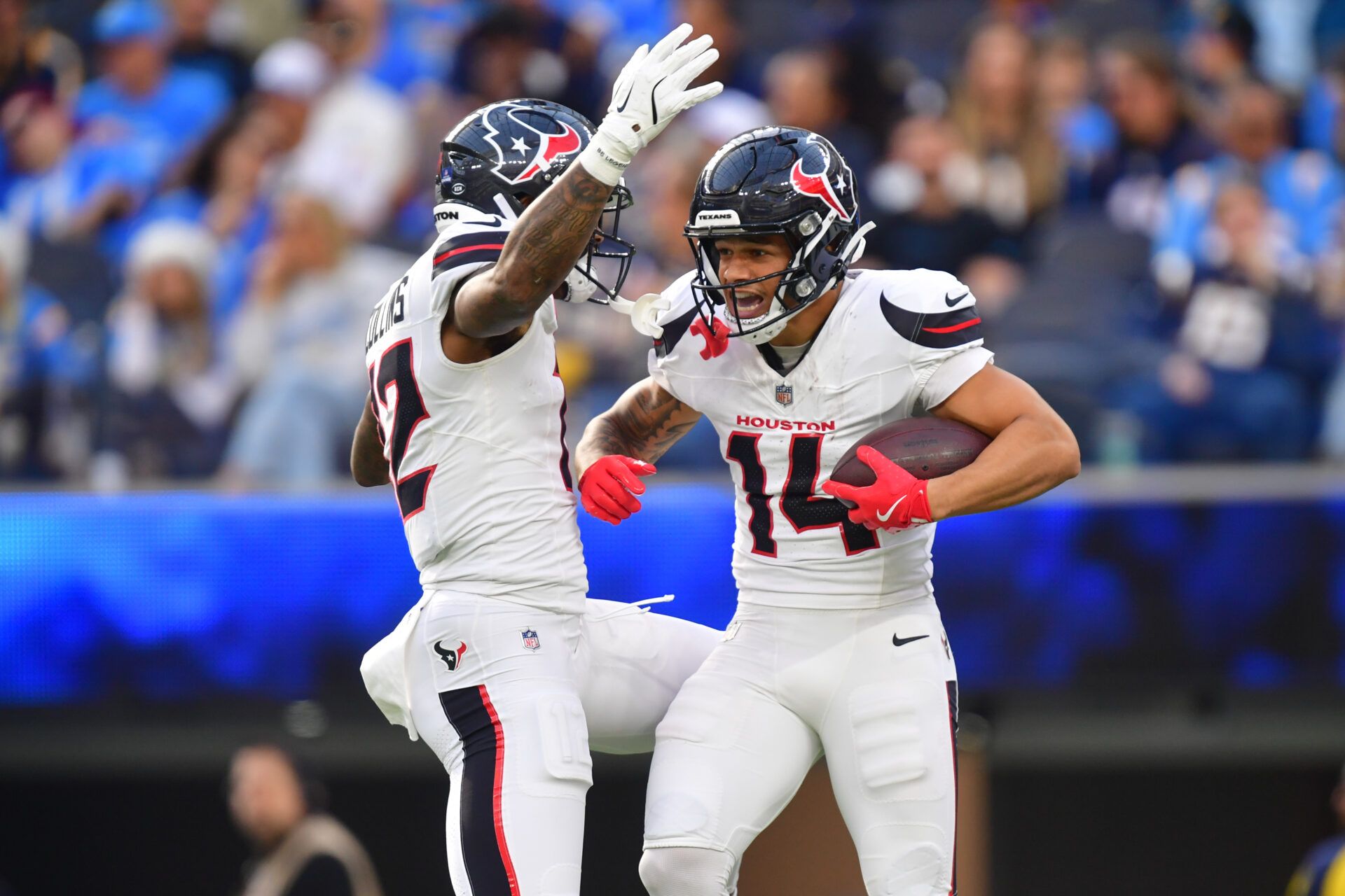 Houston Texans wide receiver Jaylin Noel (14) reacts with wide receiver Nico Collins (12) after catching a touchdown against the Los Angeles Chargers during the first half at SoFi Stadium.