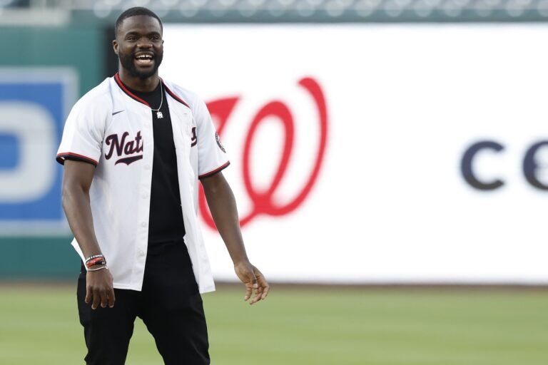 ATP world top ten men's singles tennis player Frances Tiafoe smiles after throwing out the ceremonial first pitch prior to the game between the Miami Marlins and Washington Nationals at Nationals Park.