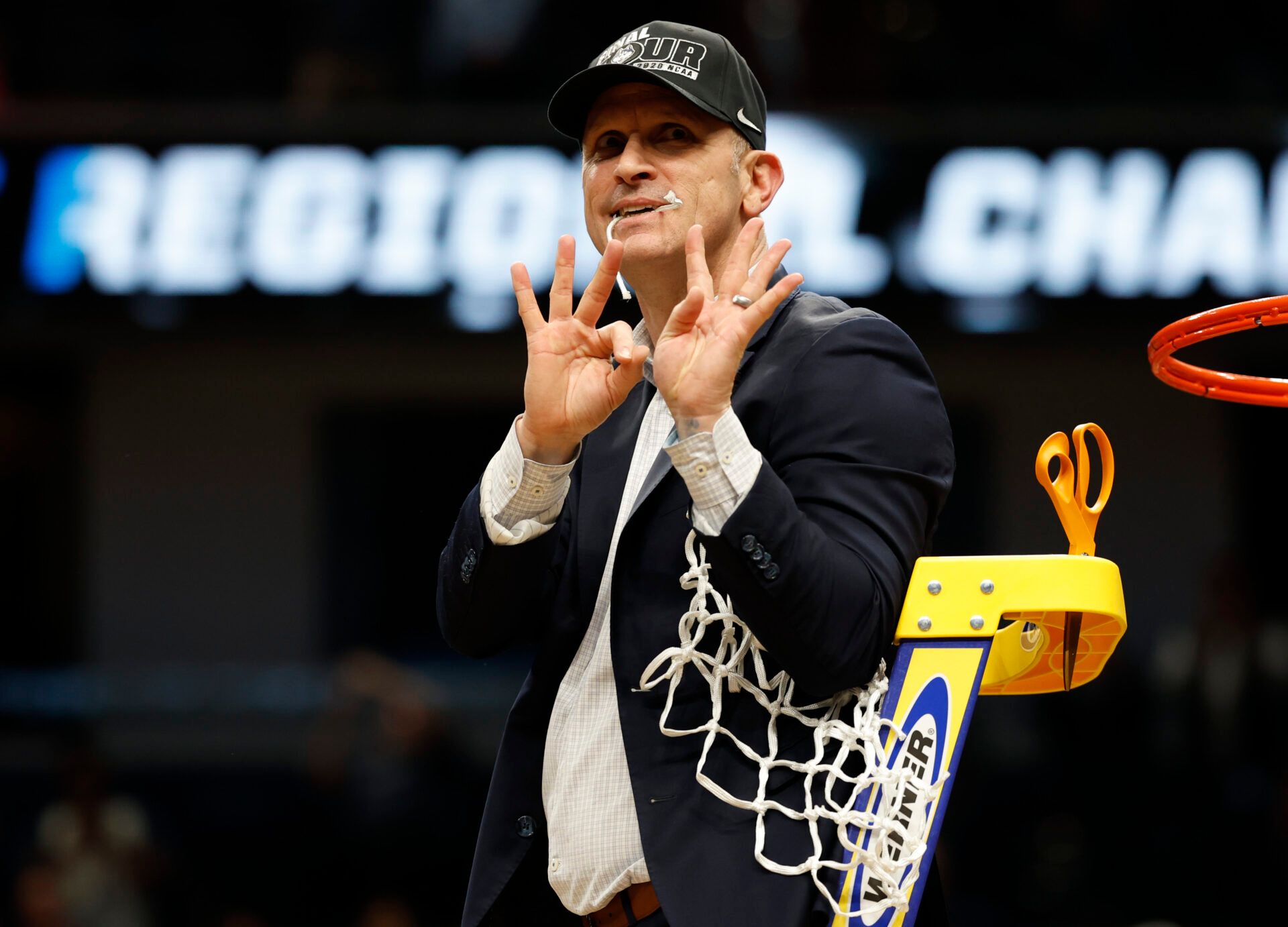 UConn Huskies head coach Dan Hurley celebrates after cutting down the net after defeating the Duke Blue Devils in an Elite Eight game of the East Regional of the men's 2026 NCAA Tournament at Capital One Arena.