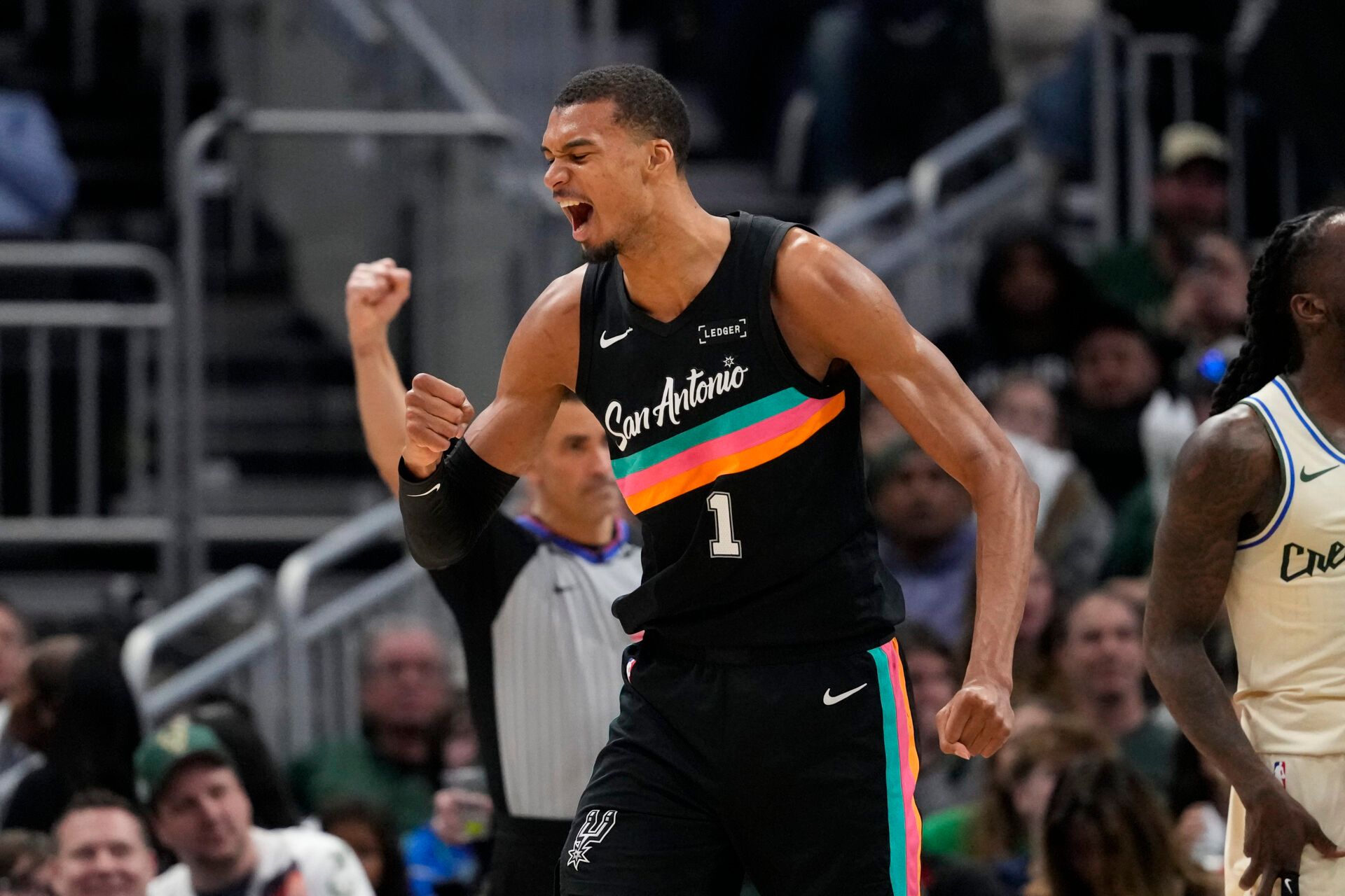 San Antonio Spurs forward Victor Wembanyama (1) celebrates after scoring a basket during the fourth quarter against the Milwaukee Bucks at Fiserv Forum.