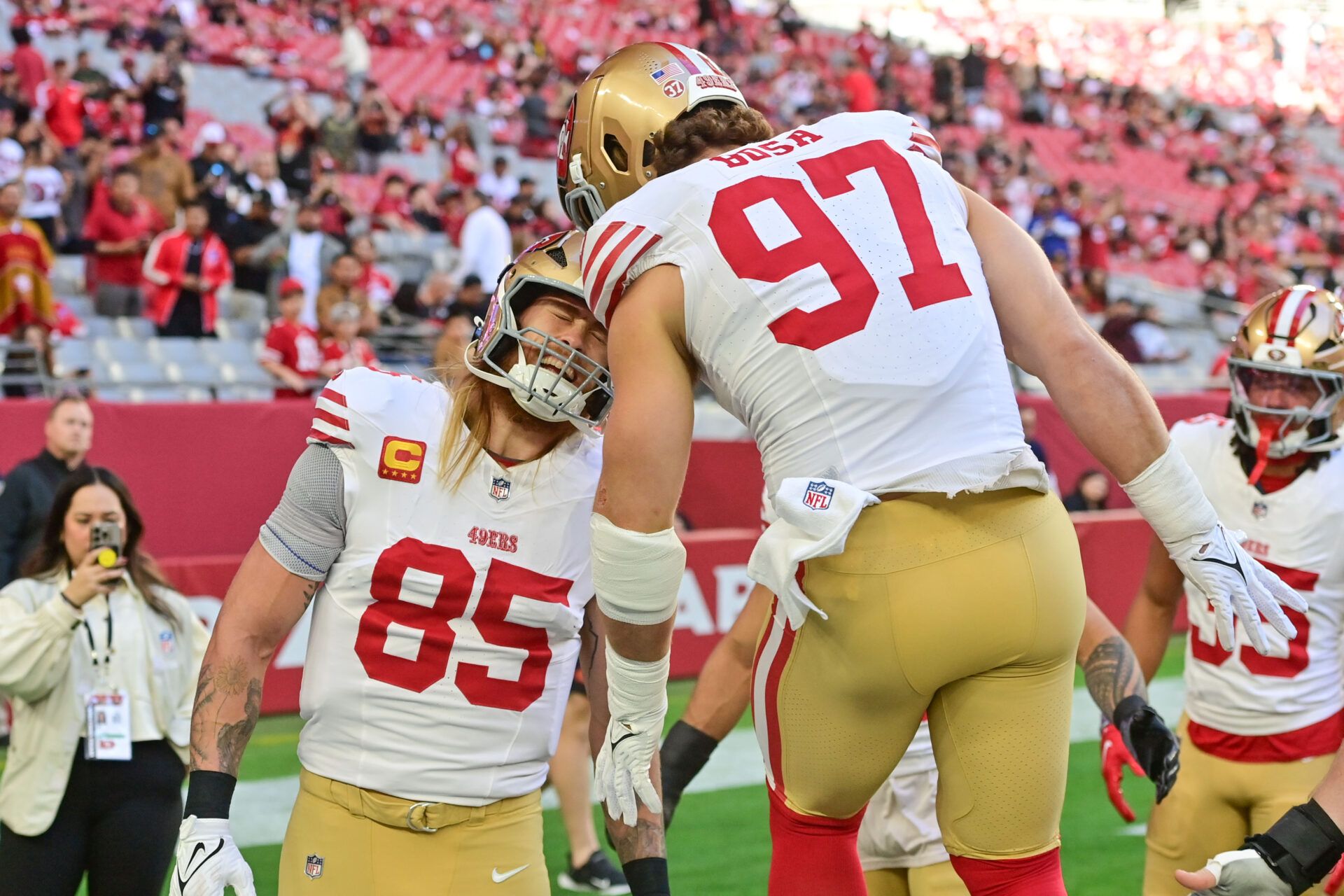 San Francisco 49ers tight end George Kittle (85) and defensive end Nick Bosa (97) greet each other prior to the game against the Arizona Cardinals at State Farm Stadium.