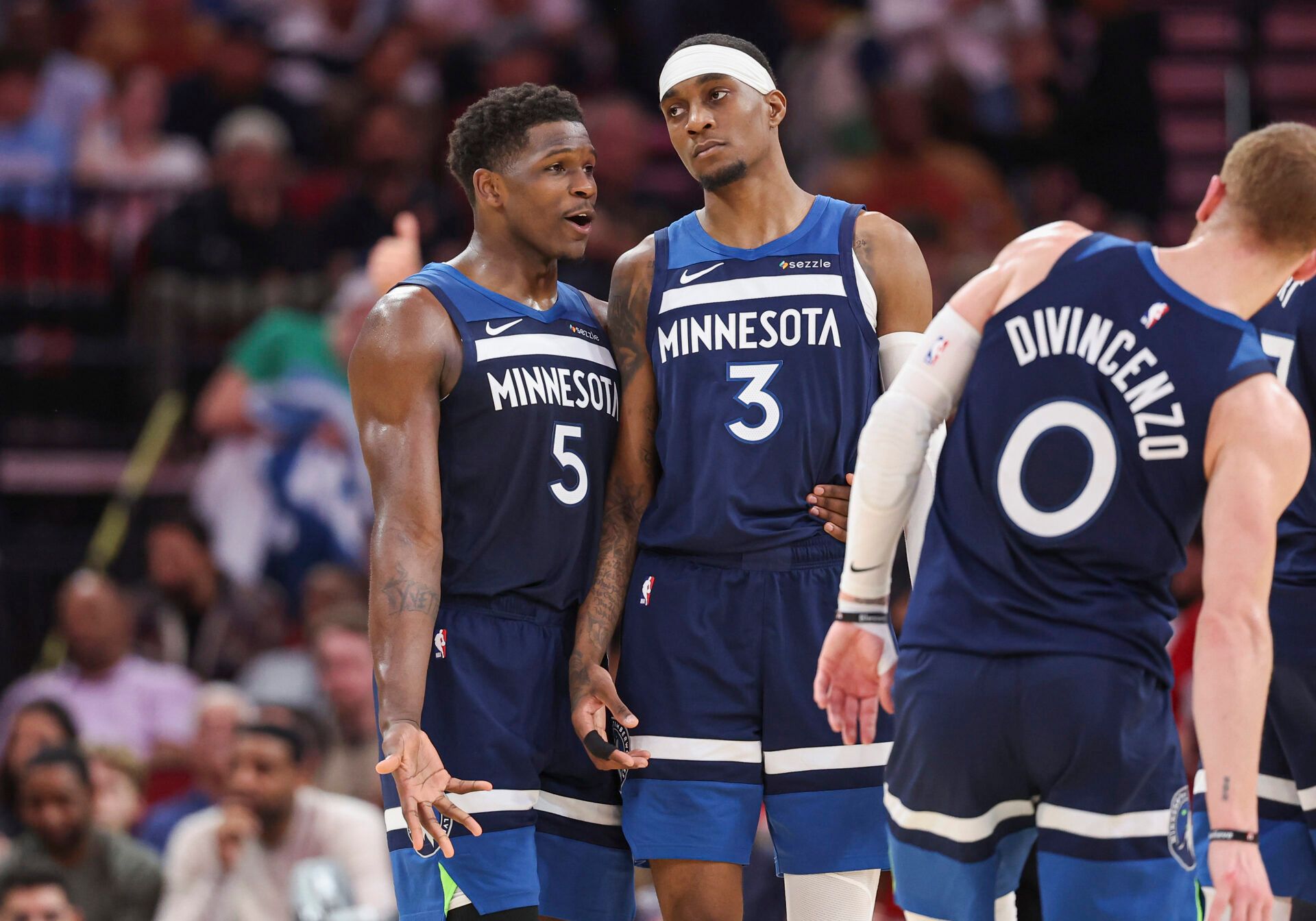 Minnesota Timberwolves guard Anthony Edwards (5) talks with forward Jaden McDaniels (3) during the second quarter against the Houston Rockets at Toyota Center.