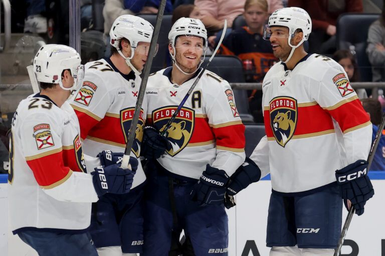 Florida Panthers left wing Matthew Tkachuk (19) celebrates his goal against the New York Islanders with centers Carter Verhaeghe (23) and Eetu Luostarinen (27) and defenseman Seth Jones (3) during the first period at UBS Arena.