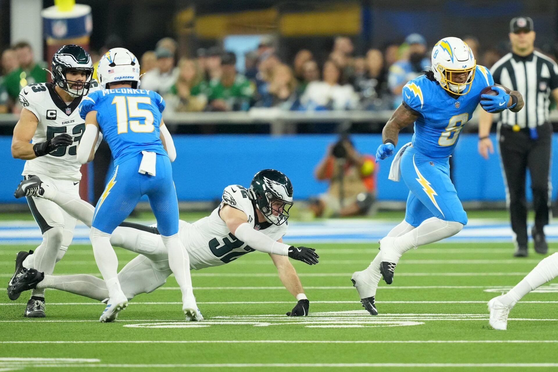 Los Angeles Chargers running back Omarion Hampton (8) runs against Philadelphia Eagles safety Reed Blankenship (32) in the first half at SoFi Stadium.