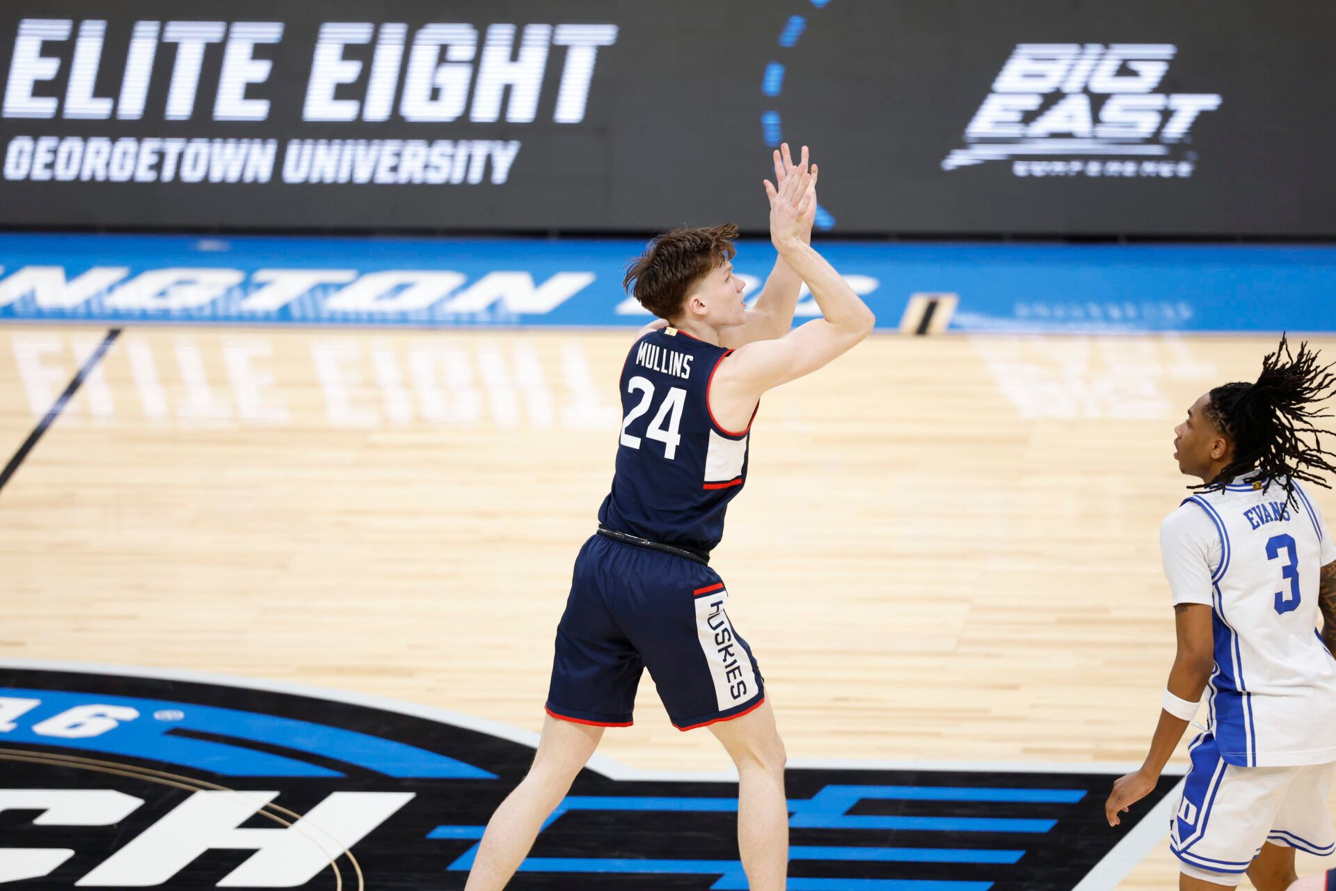 UConn Huskies guard Braylon Mullins (24) watches his game-winning three-point basket in the second half in front of Duke Blue Devils guard Isaiah Evans (3) during an Elite Eight game of the East Regional of the men's 2026 NCAA Tournament at Capital One Arena.