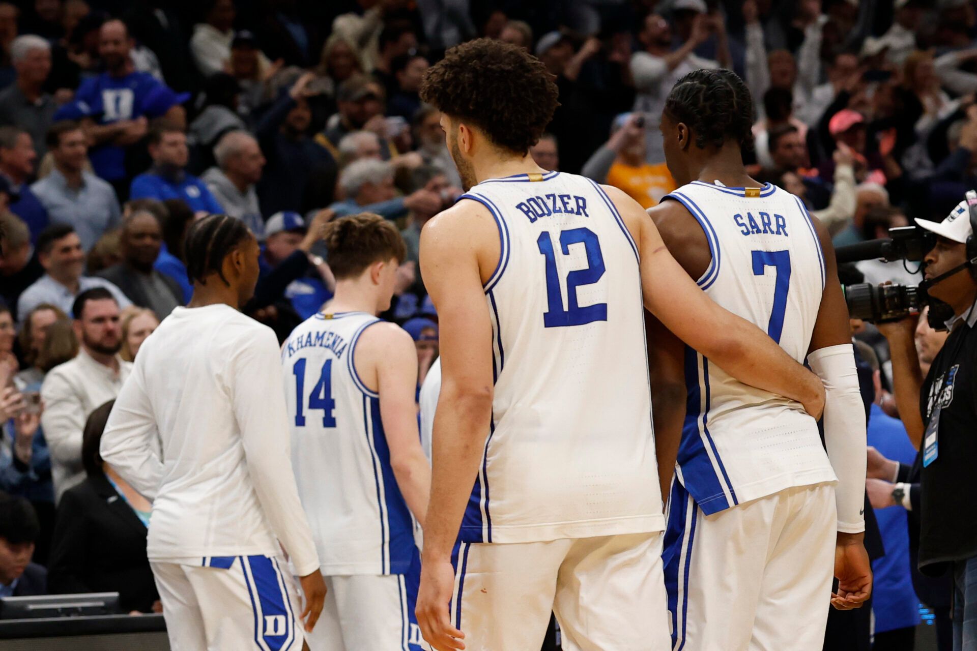 Duke Blue Devils forward Cameron Boozer (12) hugs Blue Devils guard Dame Sarr (7) after their game against the UConn Huskies in an Elite Eight game of the East Regional of the men's 2026 NCAA Tournament at Capital One Arena.