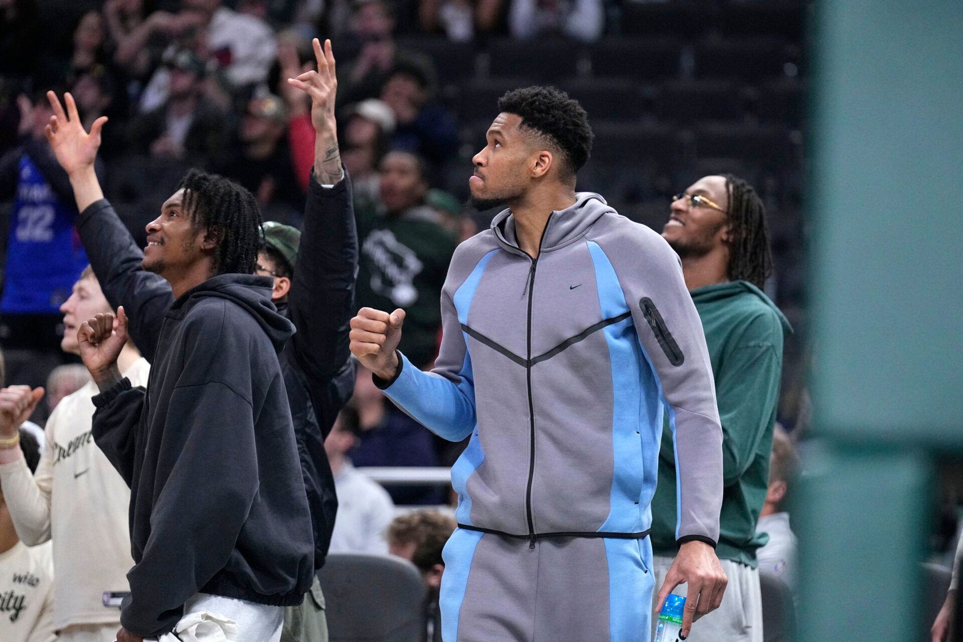 Milwaukee Bucks guard/forward Kevin Porter Jr. (7), Milwaukee Bucks forward Giannis Antetokounmpo (34) and Milwaukee Bucks center/forward Myles Turner (3) react to a late fourth quarter rally by the Milwaukee Bucks against the LA Clippers in the second half at Fiserv Forum.