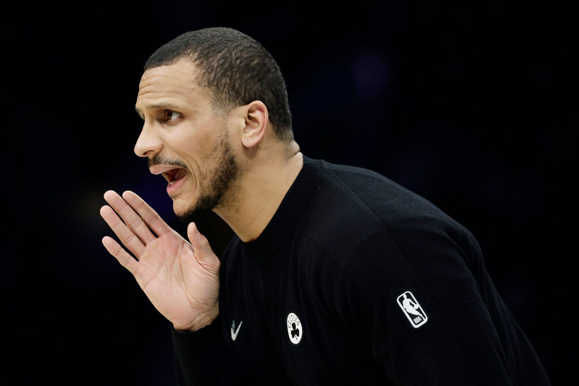 Boston Celtics Head Coach Joe Mazzulla yells instructions to his team from the sideline during the second half against the Charlotte Hornets at Spectrum Center.