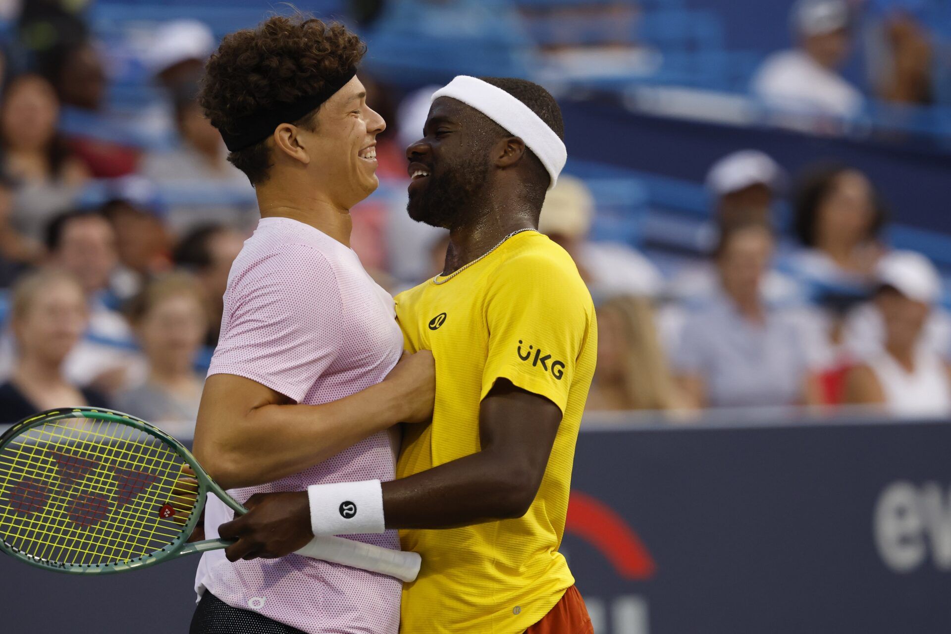 Ben Shelton (USA)(L), hugs partner Frances Tiafoe (USA)(R) after winning a point against Matthew Ebden and John Peers (both of AUS)(both not pictured) in a men's doubles match on day one of the Mubadala Citi DC Open at Rock Creek Park Tennis Center.