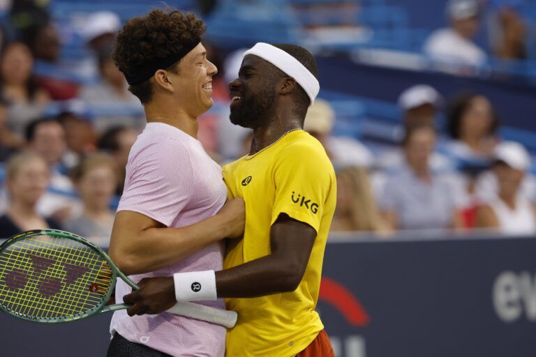 Ben Shelton (USA)(L), hugs partner Frances Tiafoe (USA)(R) after winning a point against Matthew Ebden and John Peers (both of AUS)(both not pictured) in a men's doubles match on day one of the Mubadala Citi DC Open at Rock Creek Park Tennis Center.