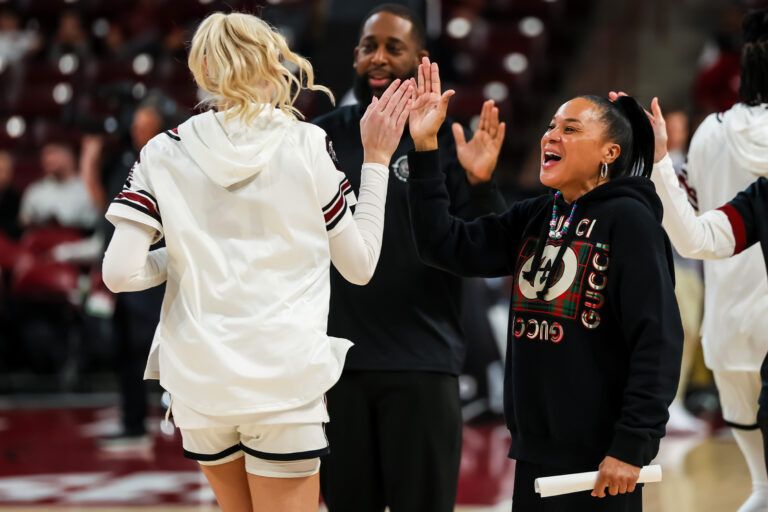 South Carolina Gamecocks head coach Dawn Staley high fives forward Chloe Kitts (21) before the game against the South Dakota State Jackrabbits at Colonial Life Arena.