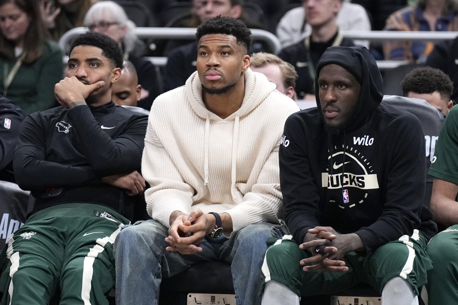 Milwaukee Bucks guard Gary Harris (11), left, Milwaukee Bucks forward Giannis Antetokounmpo (34) and Milwaukee Bucks forward Taurean Prince (12) watch the game against the Cleveland Cavaliers from the bench in the second half at Fiserv Forum.