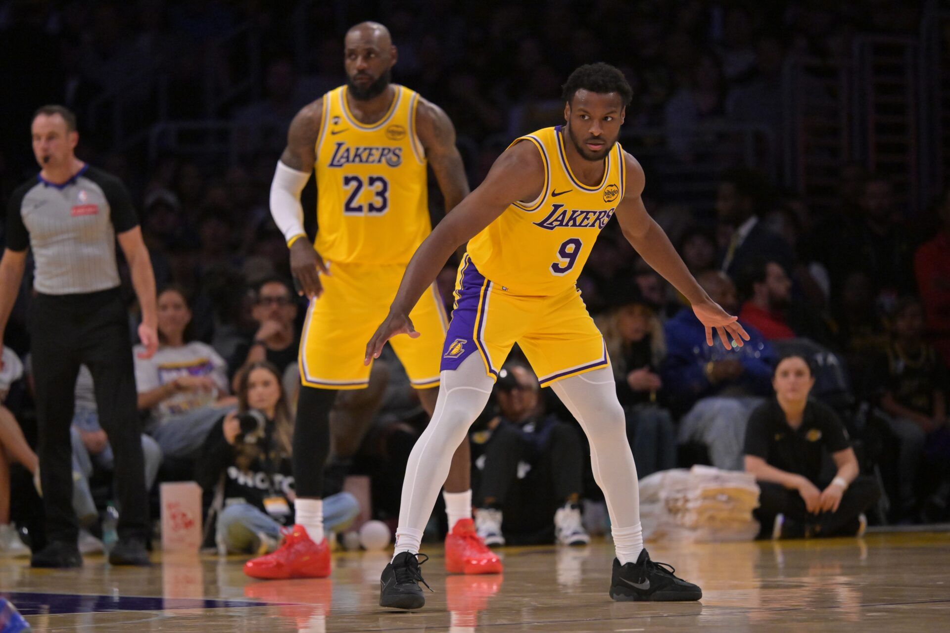 Los Angeles Lakers guard Bronny James (9) and forward LeBron James (23) defend on the court in the second half against the Washington Wizards at Crypto.com Arena.