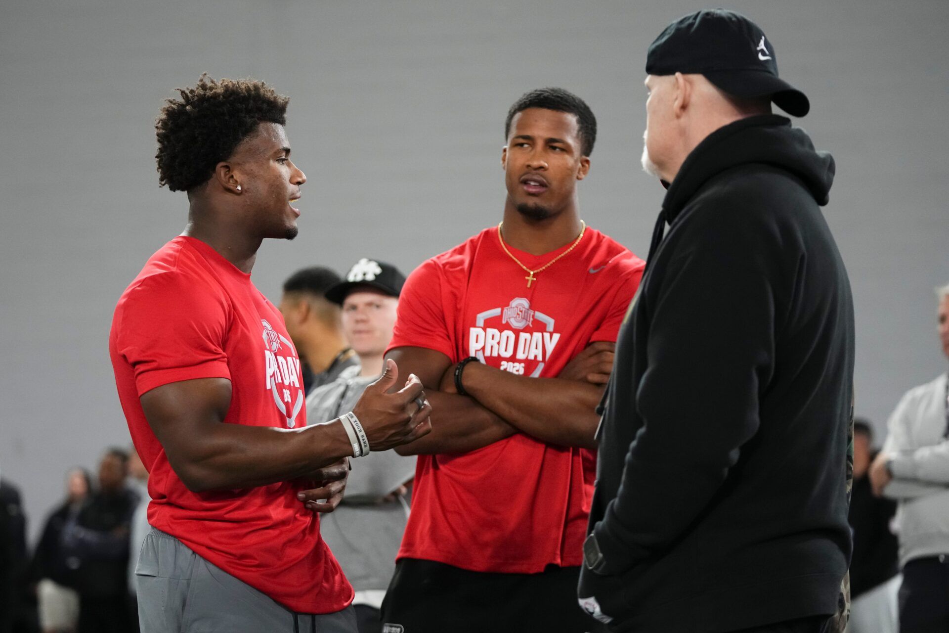 Ohio State Buckeyes defensive back Caleb Downs and linebacker Sonny Styles talk to Washington Commanders head coach Dan Quinn during Pro Day for NFL scouts at the Woody Hayes Athletics Center on March 25, 2026.