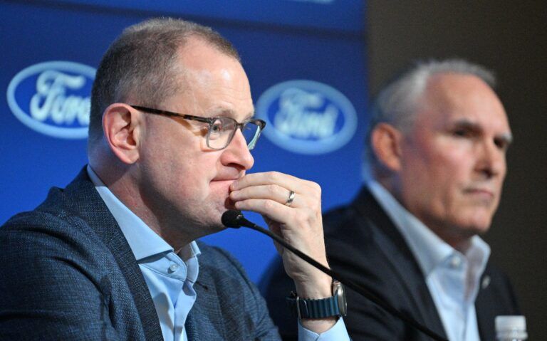 Toronto Maple Leafs general manager Brad Treliving listens to a question during a media conference to introduce new head coach Craig Berube (right) at Ford Performance Centre.