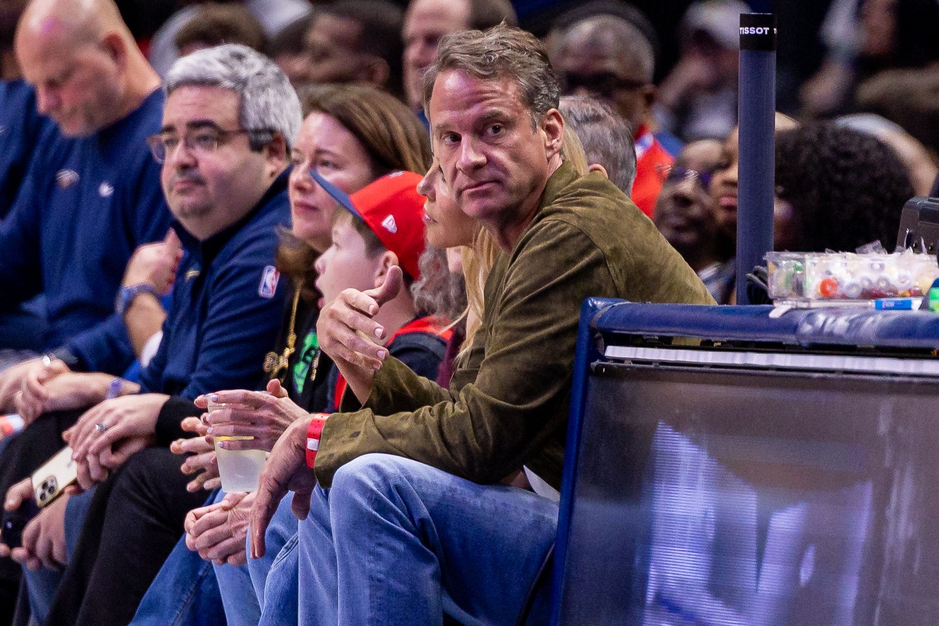 LSU football head coach Lane Kiffin looks on from the baseline at the game between the New Orleans Pelicans and the Miami Heat during the second half at Smoothie King Center.