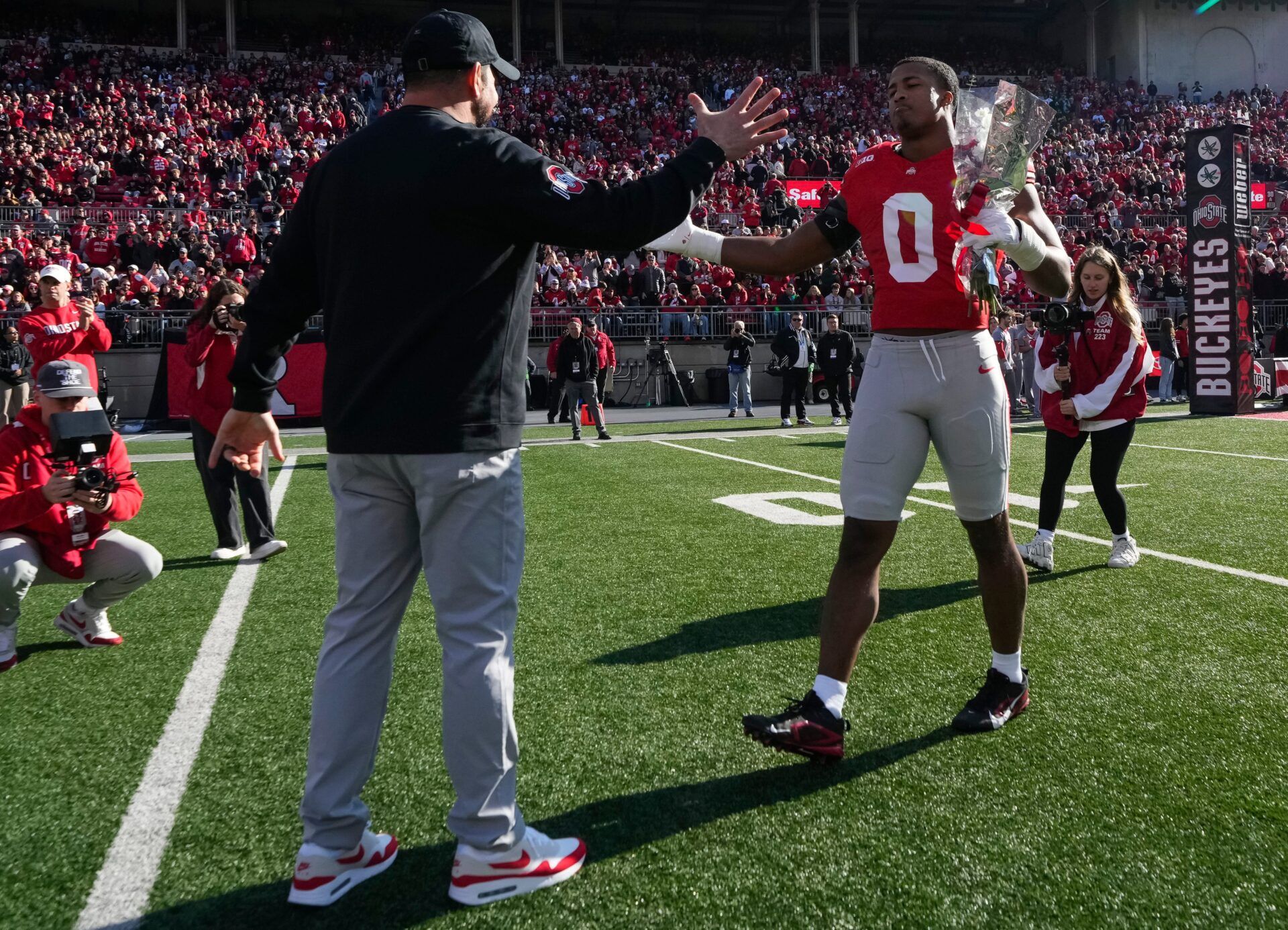 Ohio State Buckeyes head coach Ryan Day shakes hands with linebacker Sonny Styles during senior day festivities prior to the NCAA football game against the Rutgers Scarlet Knights at Ohio Stadium in Columbus on Nov. 22, 2025.