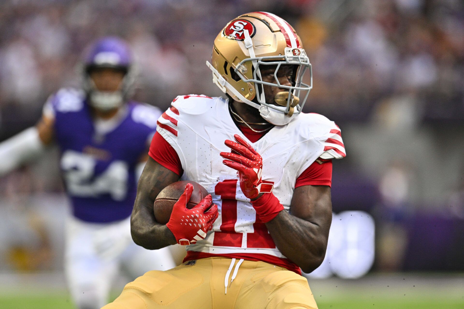 San Francisco 49ers wide receiver Brandon Aiyuk (11) looks for yards after the catch against the Minnesota Vikings during the first quarter U.S. Bank Stadium.