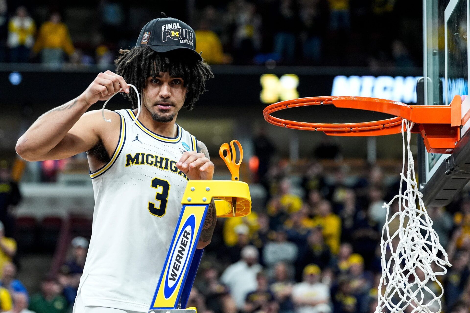 Michigan guard Elliot Cadeau (3) cuts down net to celebrate 95-62 win over Tennessee at the NCAA Tournament Midwest Regional Final at United Center in Chicago on Sunday, March 29, 2026.