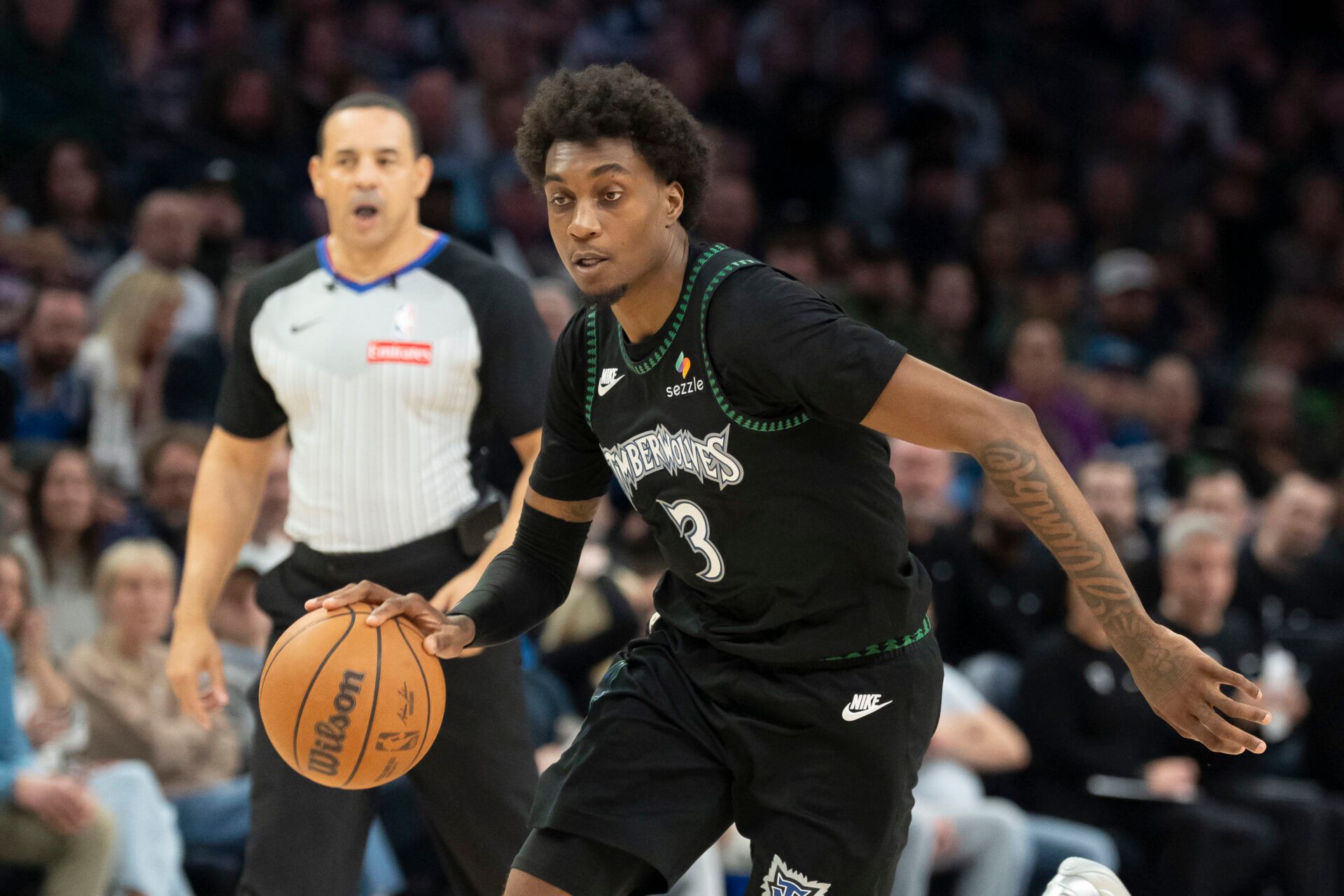 Minnesota Timberwolves forward Jaden McDaniels (3) dribbles the ball against the Portland Trail Blazers in the second half at Target Center.