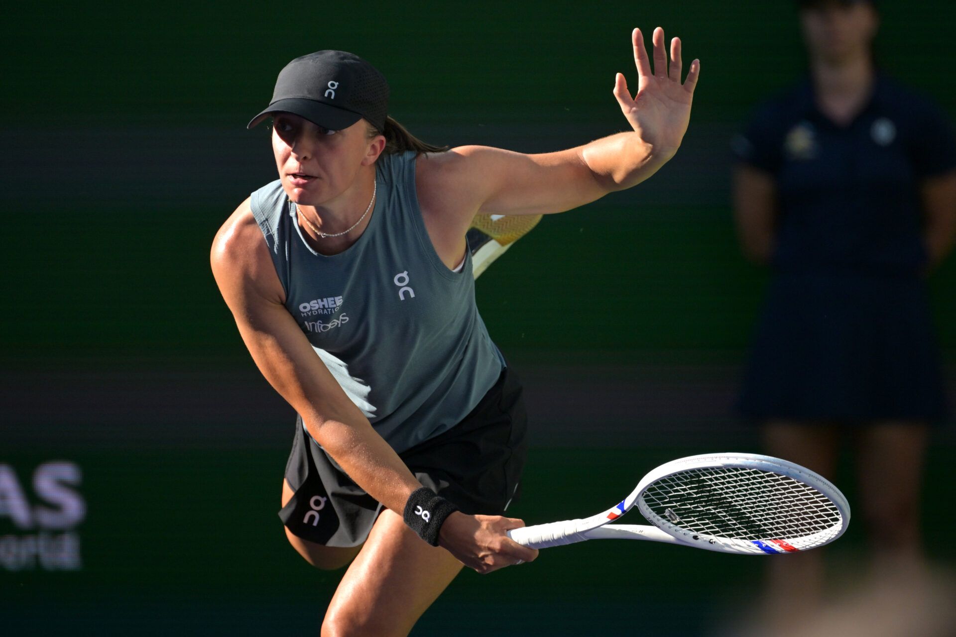Iga Swiatek (POL) serves in her quarterfinal against Elina Svitolina (UKR) during the BNP Paribas Open at the Indian Wells Tennis Garden.