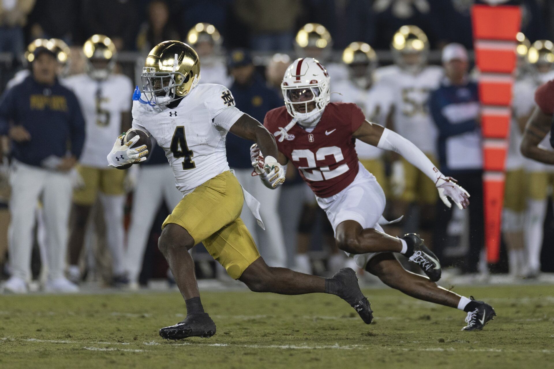Notre Dame Fighting Irish running back Jeremiyah Love (4) runs with the football during the first quarter against Stanford Cardinal safety Che Ojarikre (22) at Stanford Stadium.