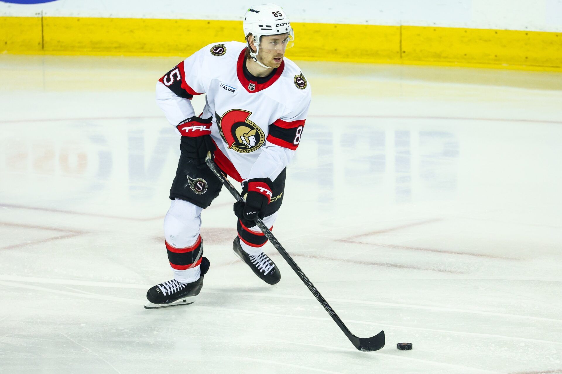 Ottawa Senators defenseman Jake Sanderson (85) skates with the puck against the Calgary Flames during the first period at Scotiabank Saddledome.
