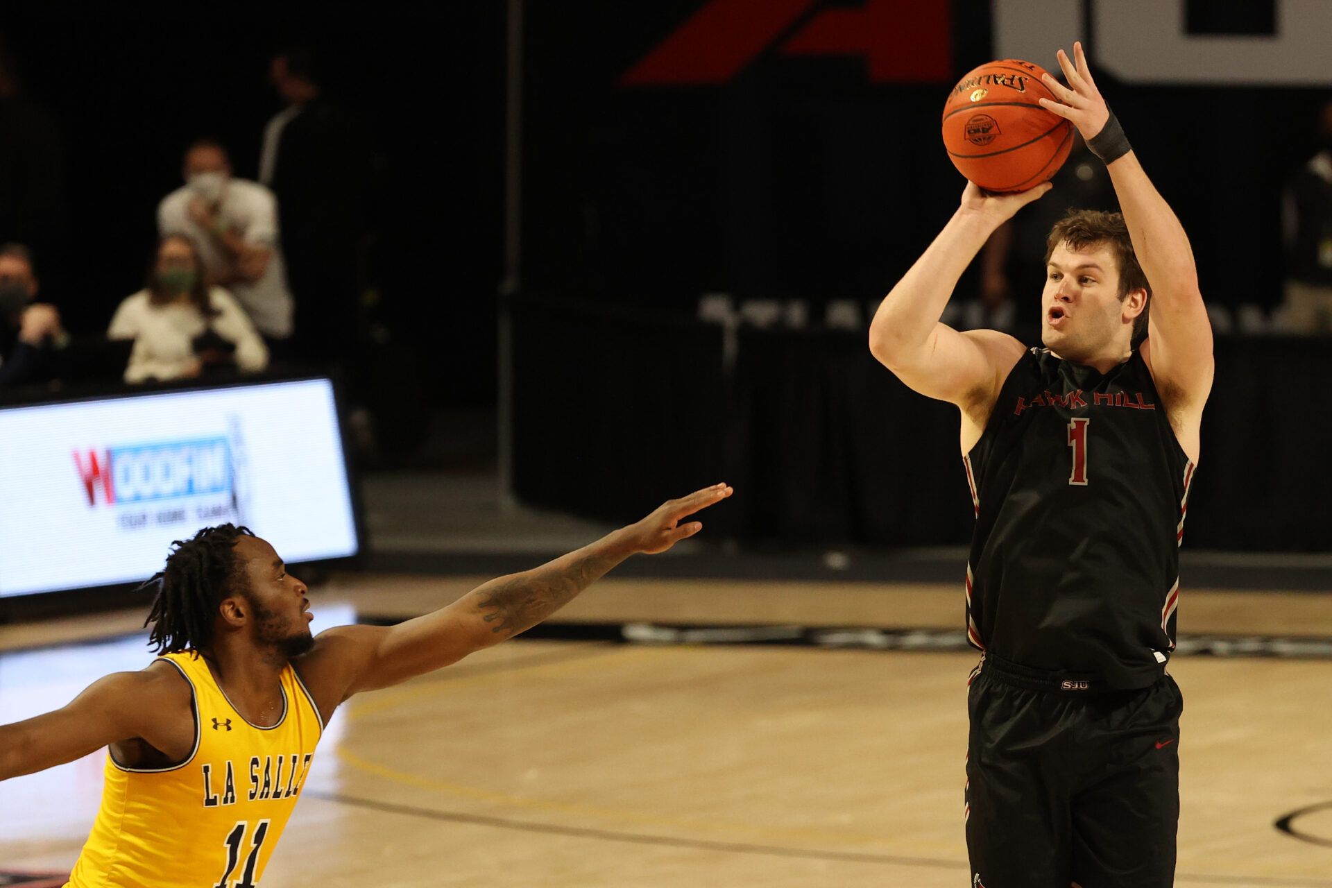 Saint Joseph's Hawks guard Ryan Daly (1) shoots the ball over La Salle Explorers guard Anwar Gill (11) in the second half in the first round of the 2021 Atlantic 10 Conference Tournament at at Stuart C. Siegel Center.