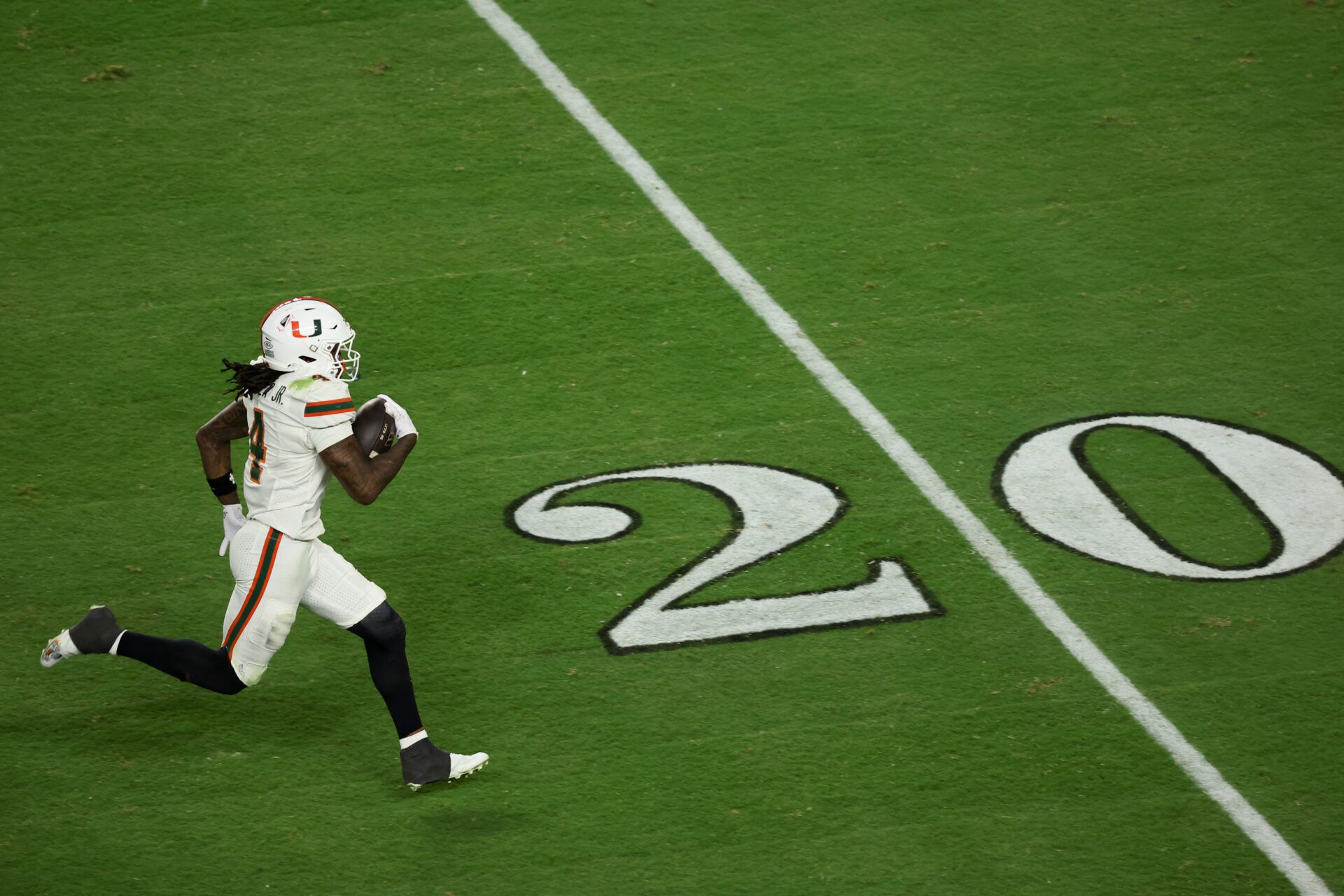 Miami Hurricanes running back Mark Fletcher Jr. (4) carries the ball for a touchdown against the Indiana Hoosiers in the third quarter during the College Football Playoff National Championship game at Hard Rock Stadium.