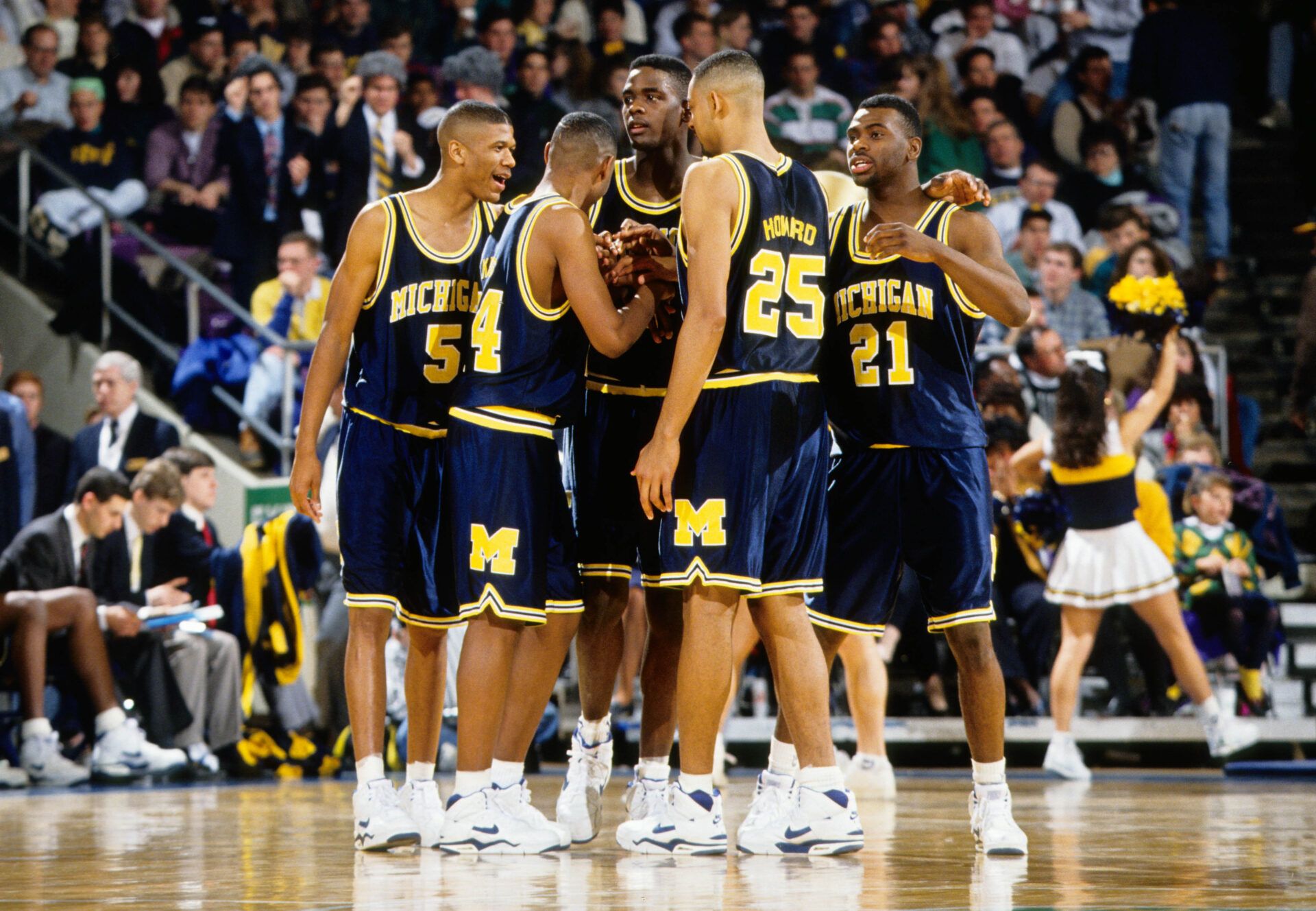 Michigan Wolverines center Chris Weber (4), Jalen Rose (5) Jimmy King (24) Juwan Howard (25), and Ray Jackson (21) huddle during a time-out against the Notre dame Irish at the Joyce Center.  The group was known as the Fab 5.