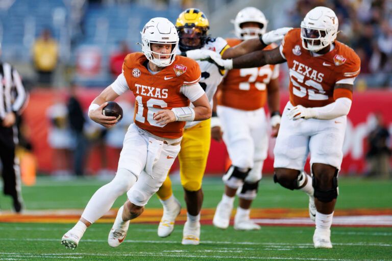 Texas Longhorns quarterback Arch Manning (16) runs with the ball against the Michigan Wolverines during the first half at Camping World Stadium.