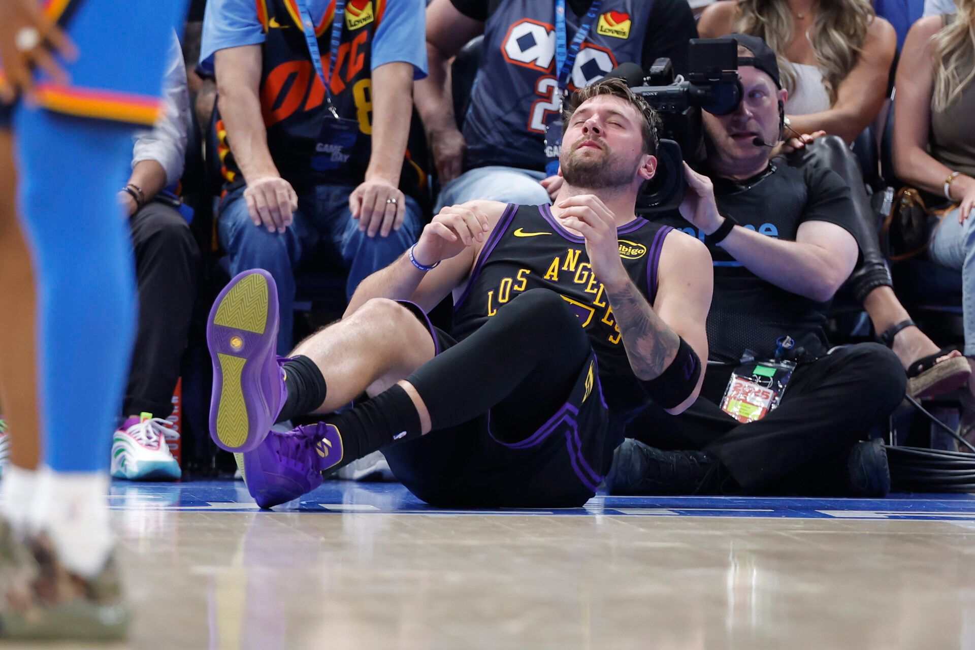Los Angeles Lakers guard Luka Doncic (77) falls to the court during a play against the Oklahoma City Thunder during the third quarter at Paycom Center.