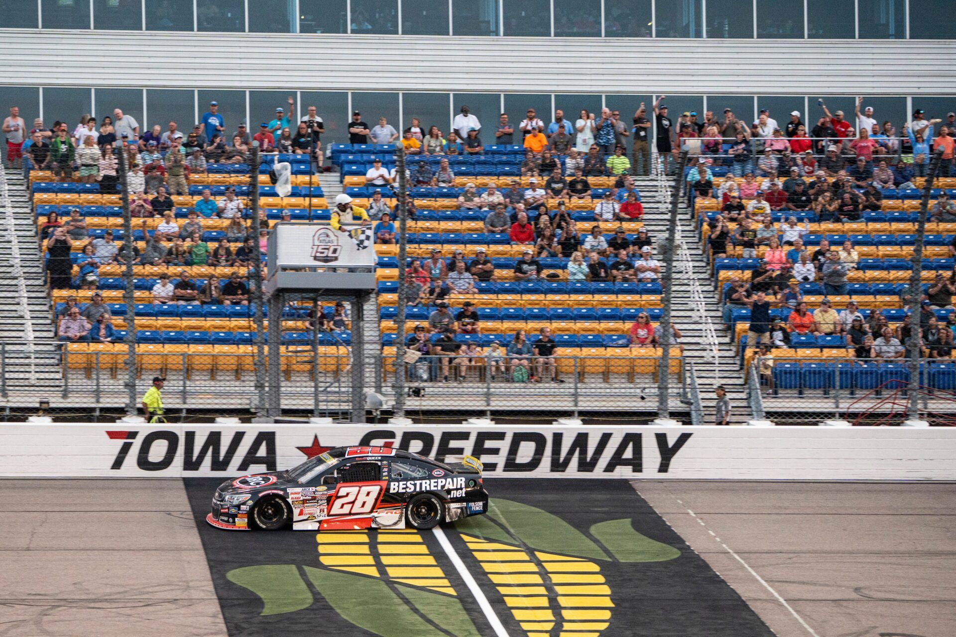 Brenden Queen (28) crosses the finish line under the checkered flag during the ARCA Menards Series Atlas Roofing 150 on Aug. 1, 2025, at Iowa Speedway in Newton, Iowa. Queen (28) finished first.