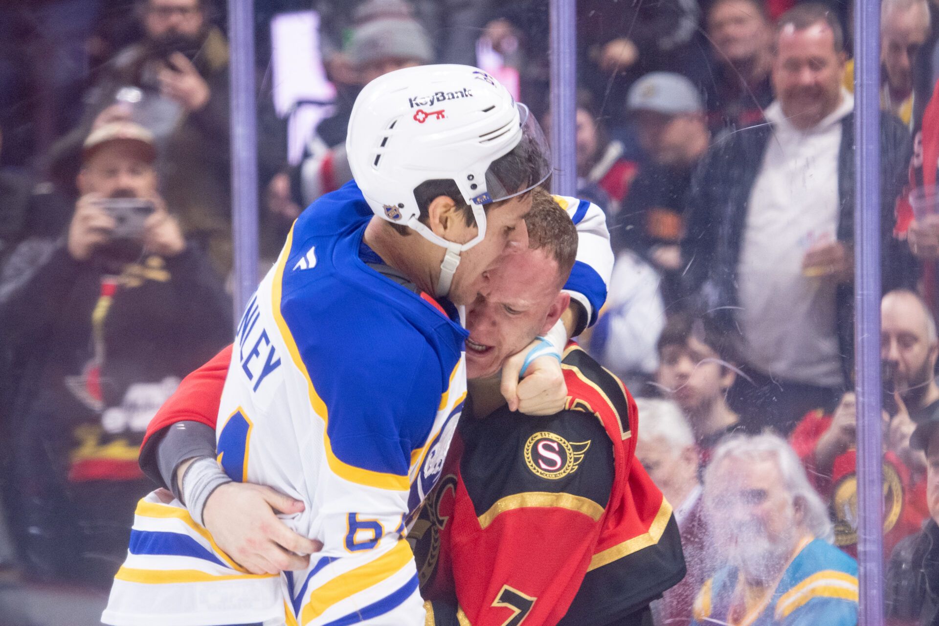 Buffalo Sabres defenseman Logan Stanley (64) fights with Ottawa Senators left wing Brady Tkachuk (7) at the Canadian Tire Centre.
